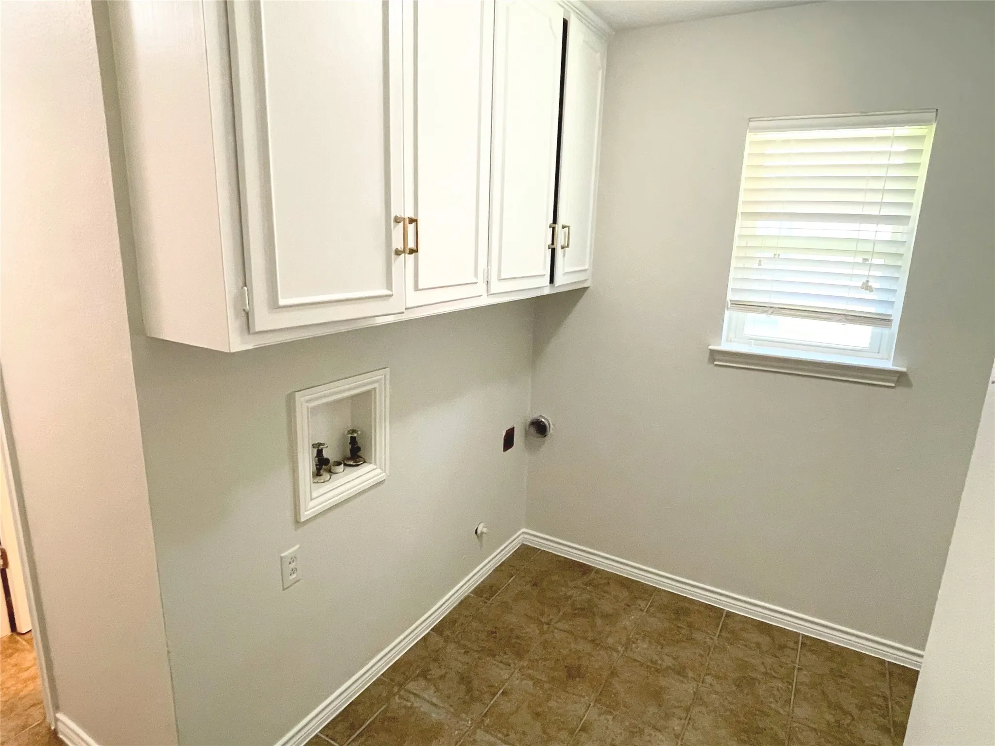 Laundry featuring hookup for a washing machine, gas dryer hookup, and cabinets