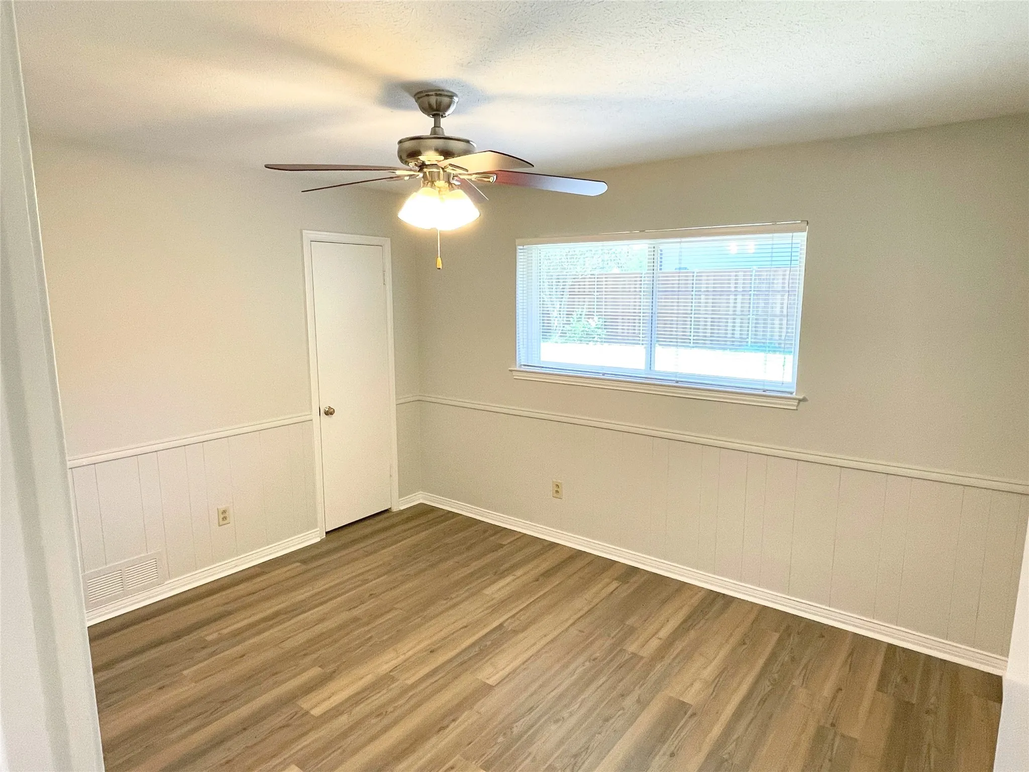 Bedroom/Office featuring wood-type flooring, ceiling fan, and a textured ceiling