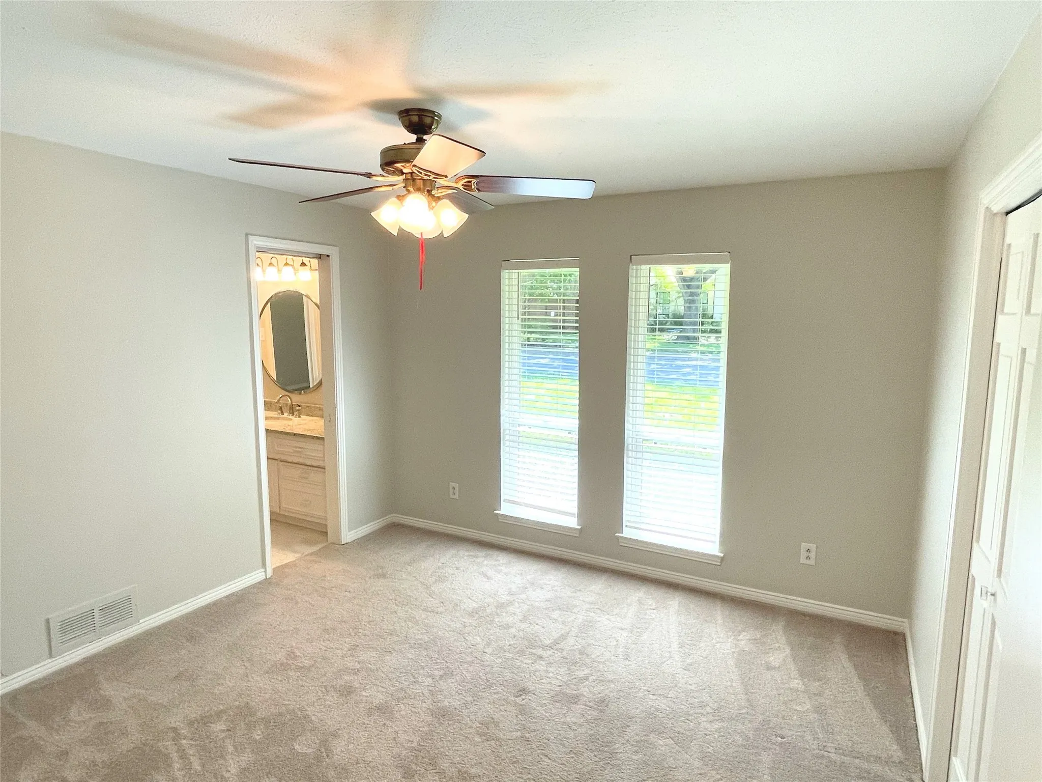 Carpeted bedroom 2featuring ceiling fan with jack and jill bath