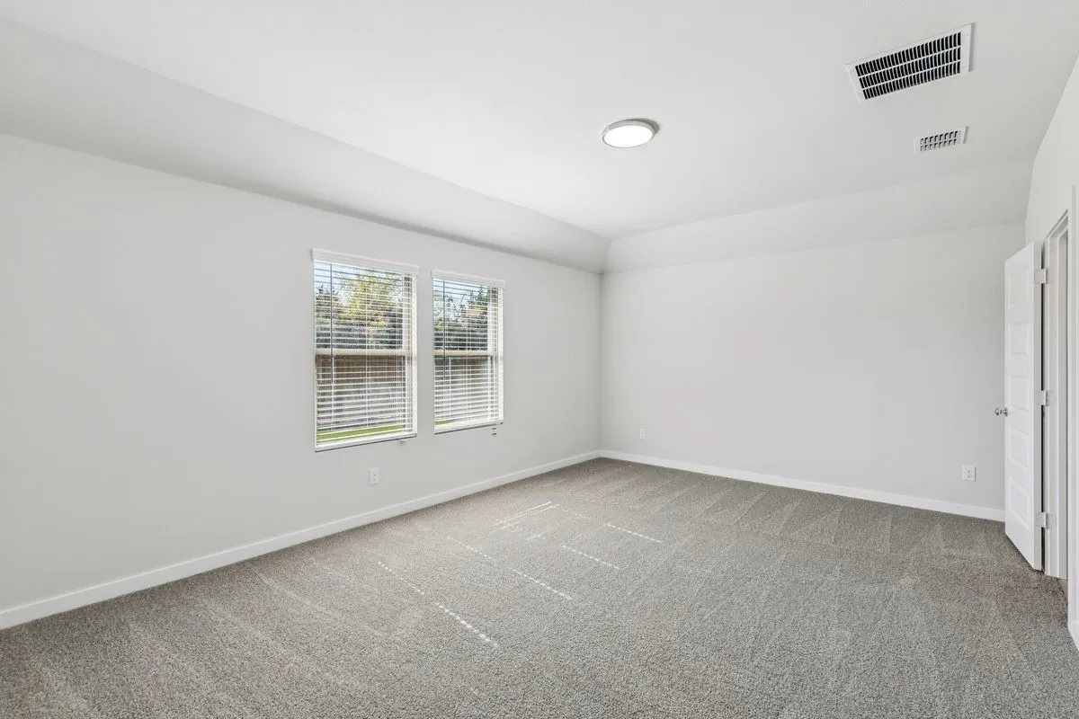 Primary Suite in the Oscar home plan by Trophy Signature Homes – REPRESENTATIVE PHOTO