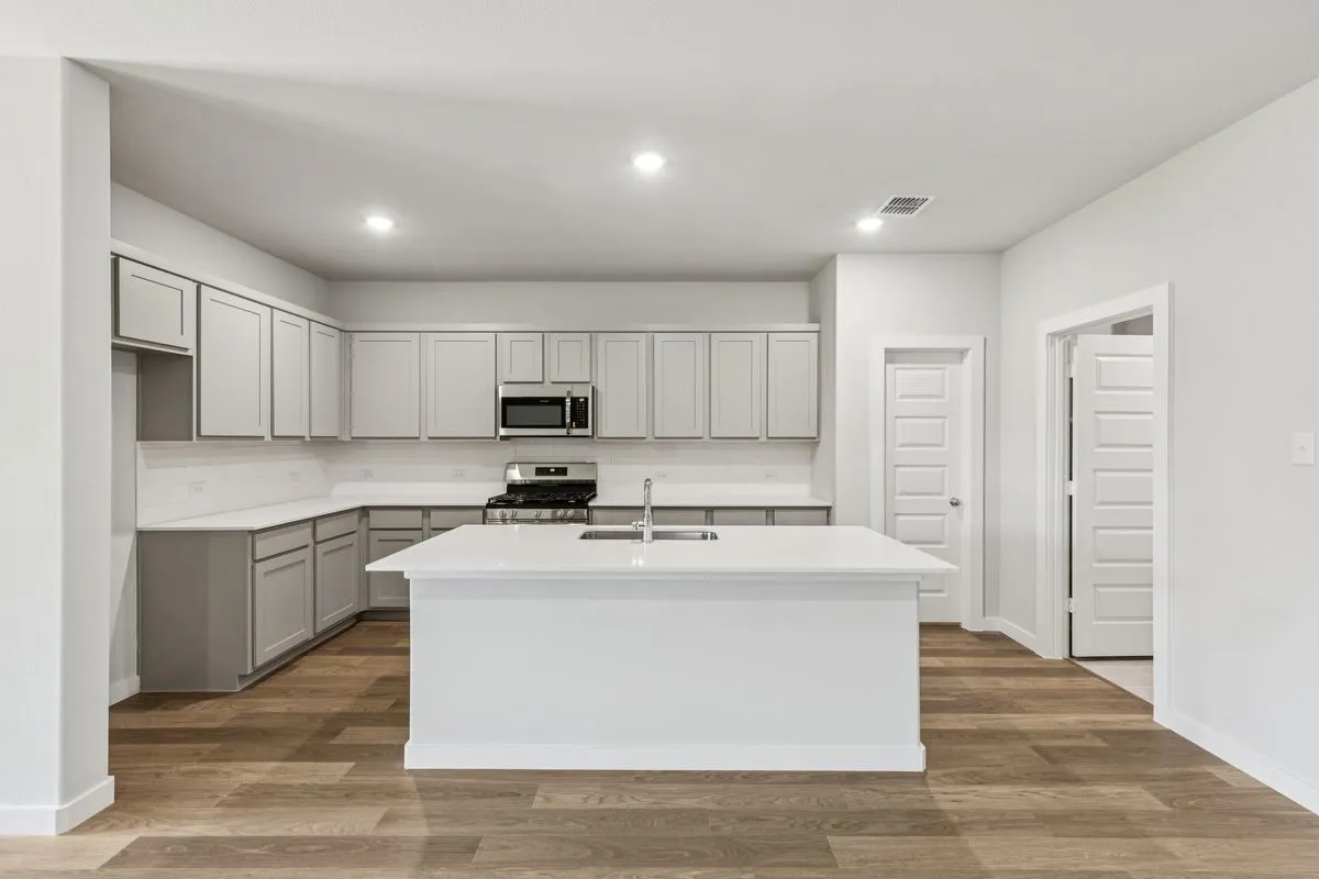 Kitchen in the Oscar home plan by Trophy Signature Homes – REPRESENTATIVE PHOTO