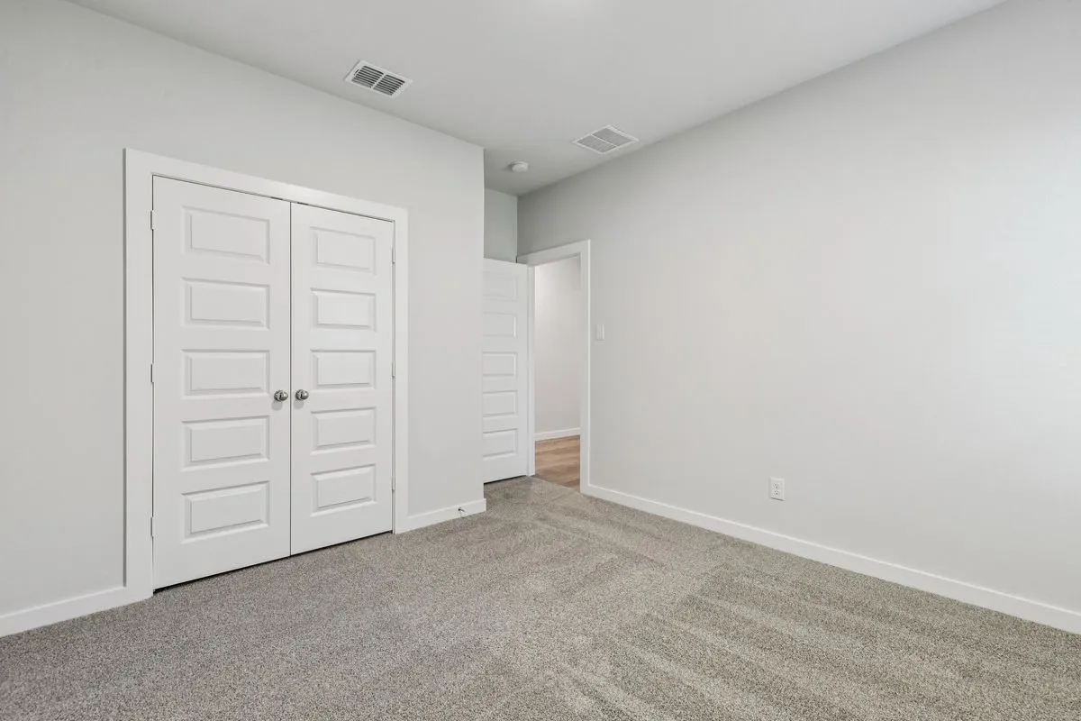 Bedroom in the Oscar home plan by Trophy Signature Homes – REPRESENTATIVE PHOTO