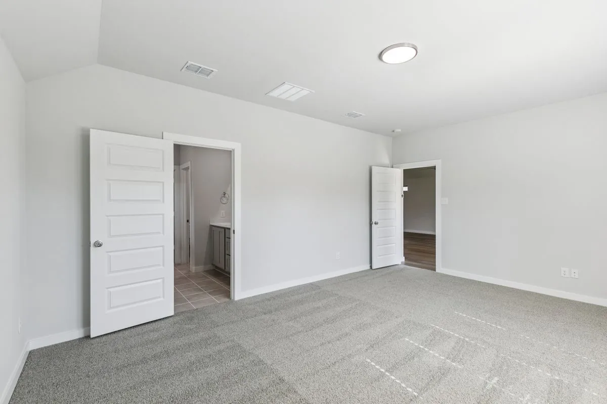 Primary Suite in the Oscar home plan by Trophy Signature Homes – REPRESENTATIVE PHOTO