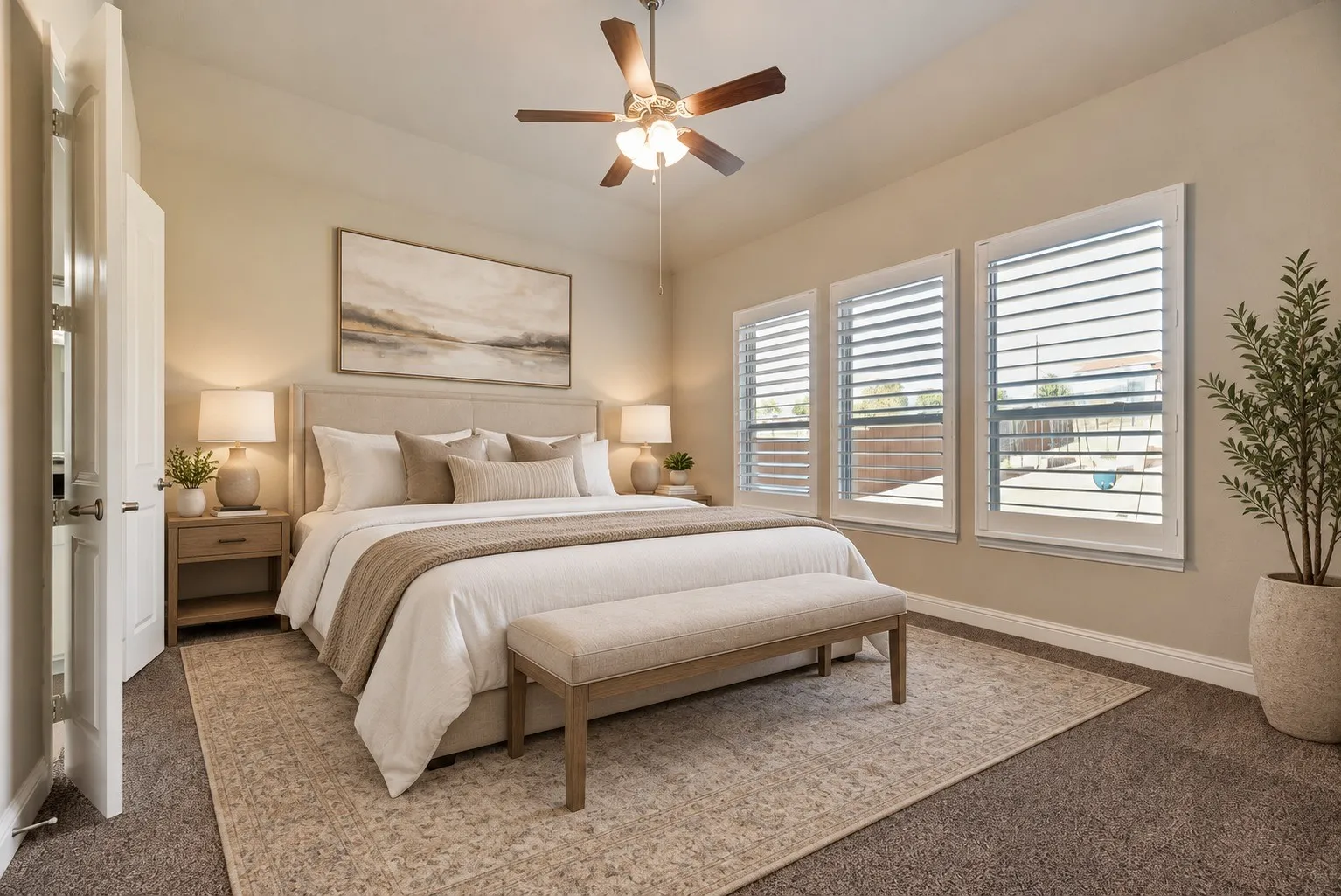 Vaulted ceiling with a ceiling fan, three windows with plantation shutters, and carpet flooring