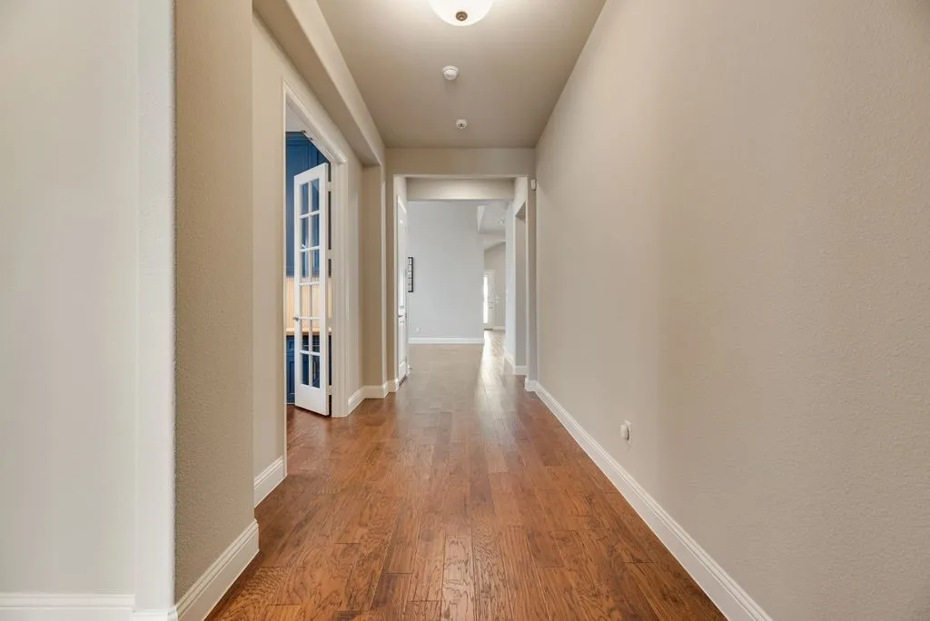 Wood-finish flooring throughout the hallway