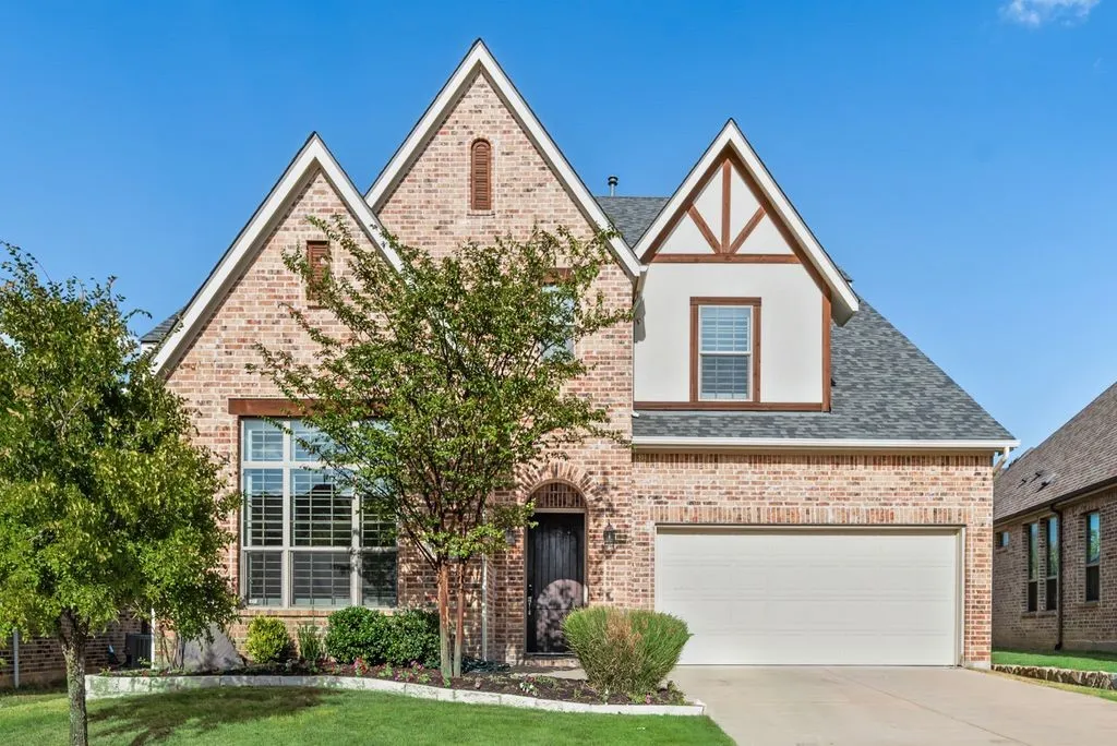 Brick facade with stone accents and multiple gables