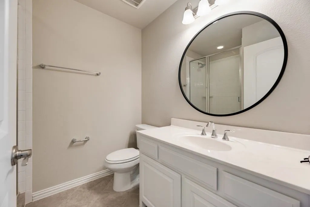 Vanity with white cabinetry, integrated sink, and polished chrome faucet