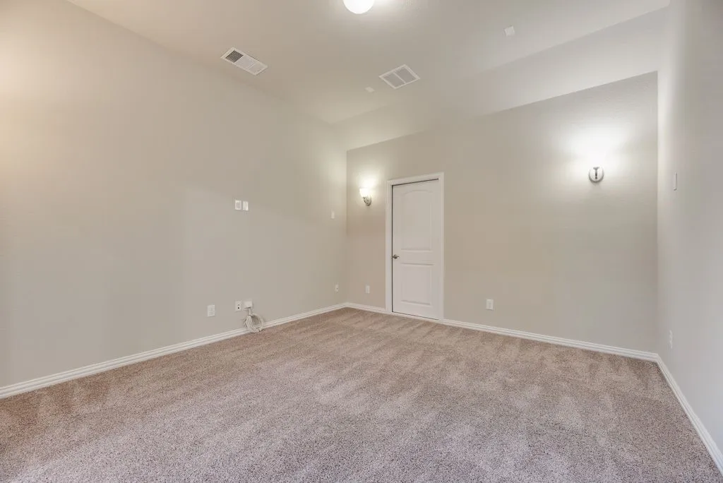 Neutral-toned walls complement the textured carpeting