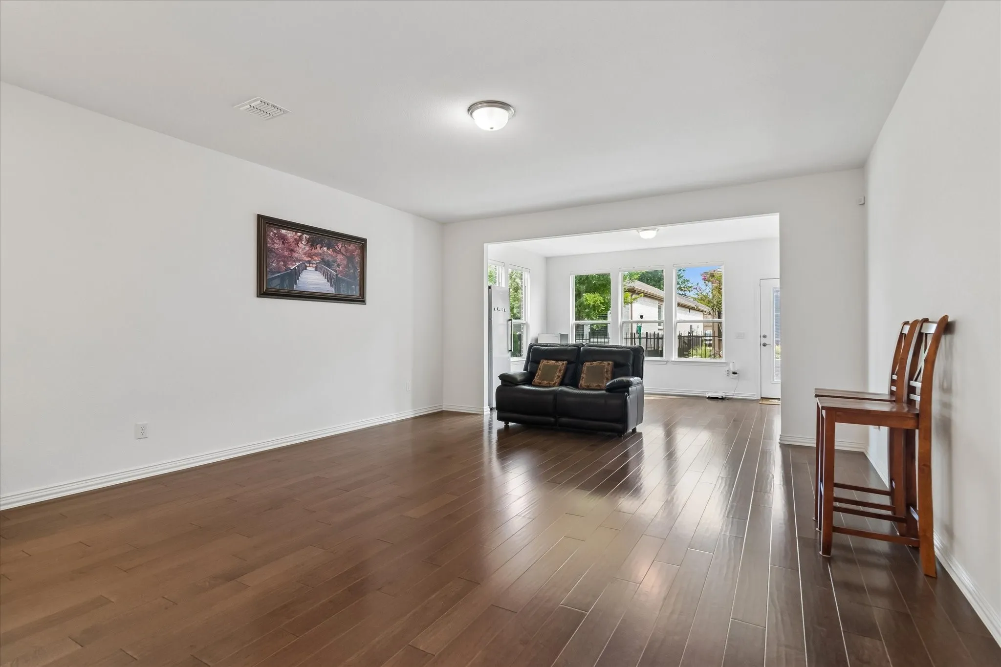 Spacious interior featuring wood-finish flooring, recessed lighting, and white walls