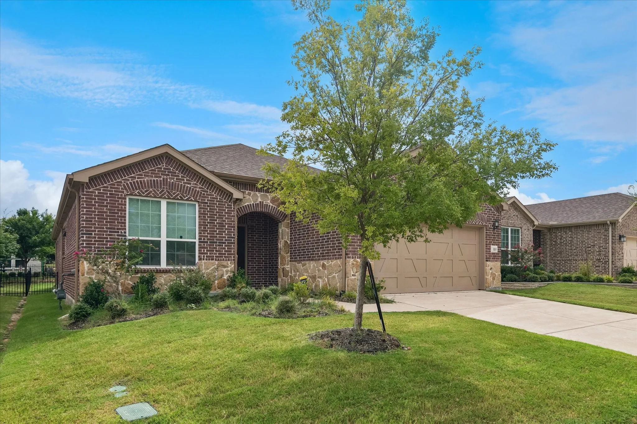 Brick and stone veneer exterior with an arched entryway