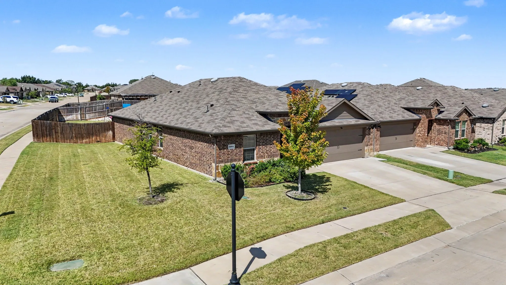 Brick exterior with a gabled roof and attached two-car garage