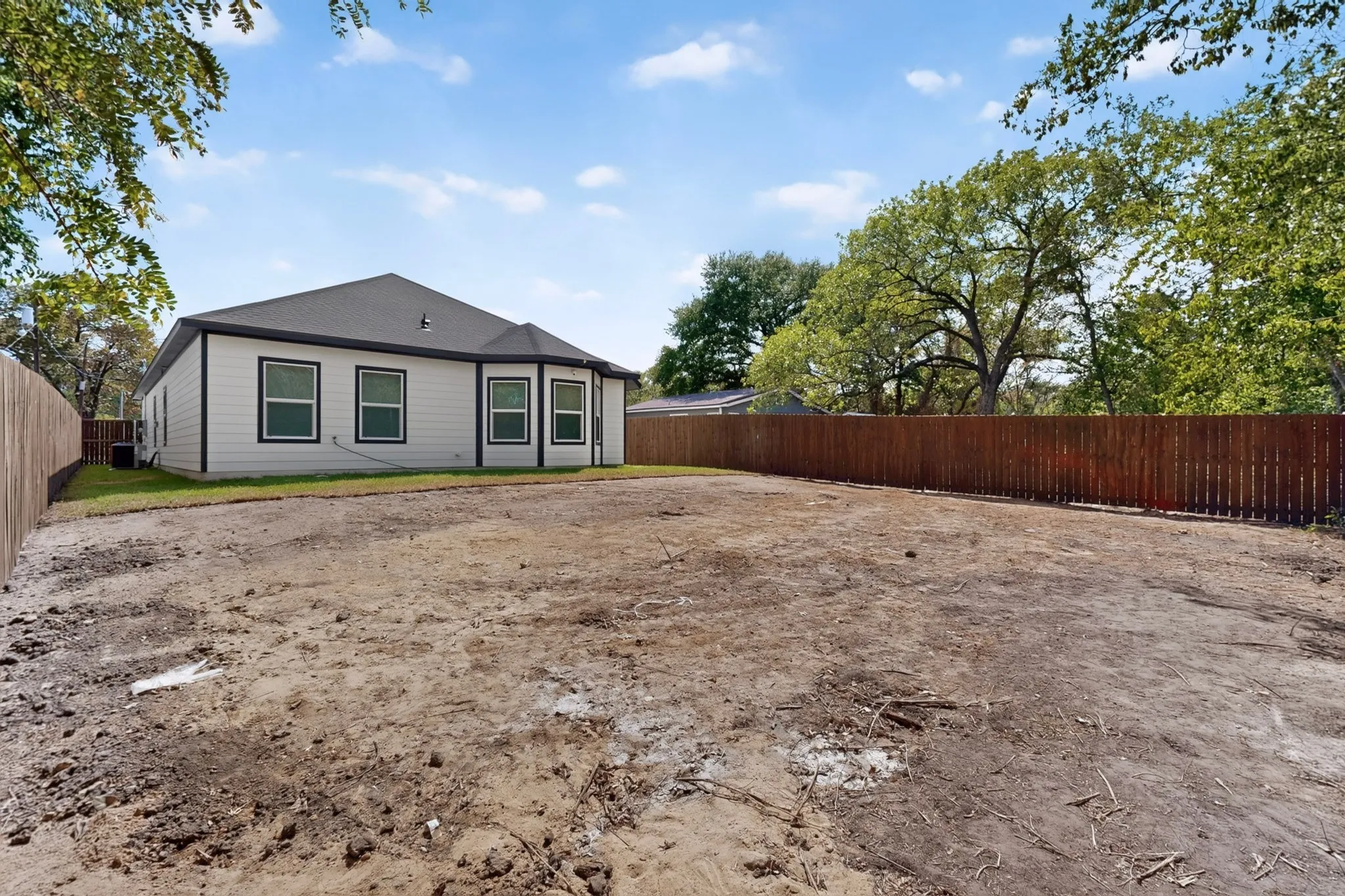 Expansive backyard with a full perimeter privacy fence.