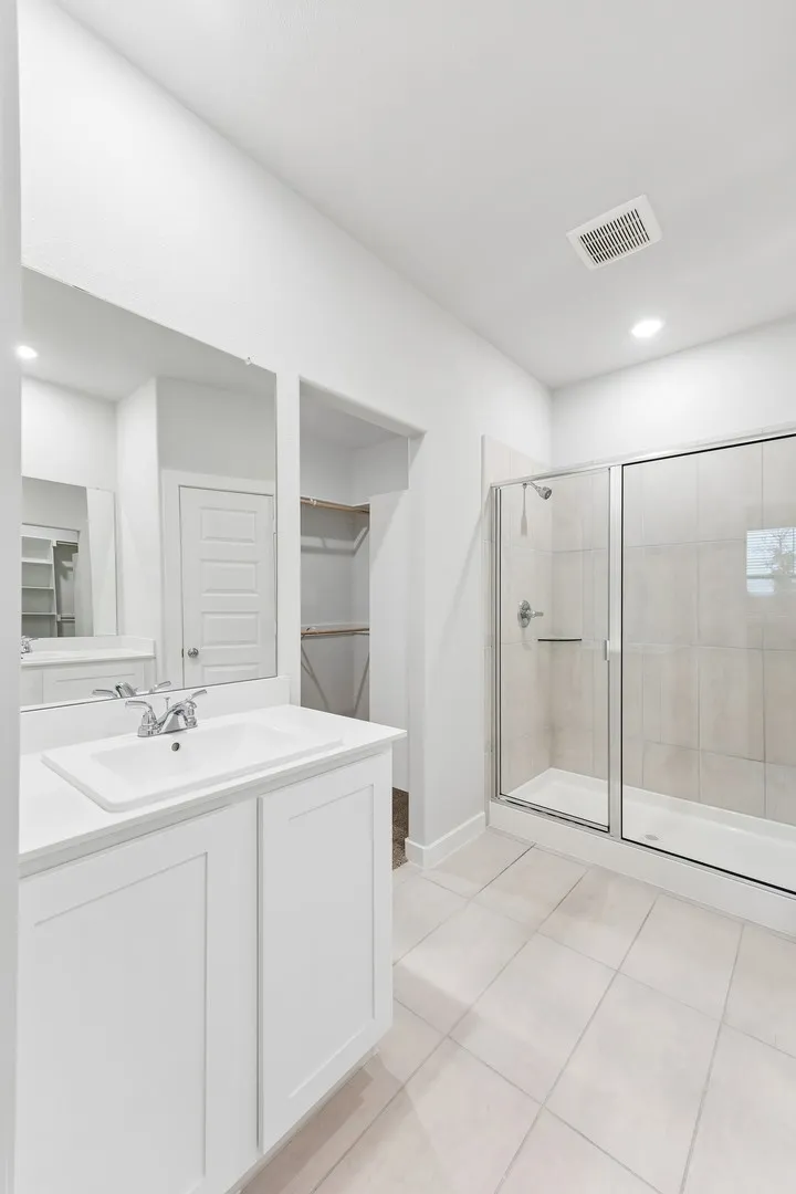 Primary Bathroom in the Cedar home plan by Trophy Signature Homes – REPRESENTATIVE PHOTO