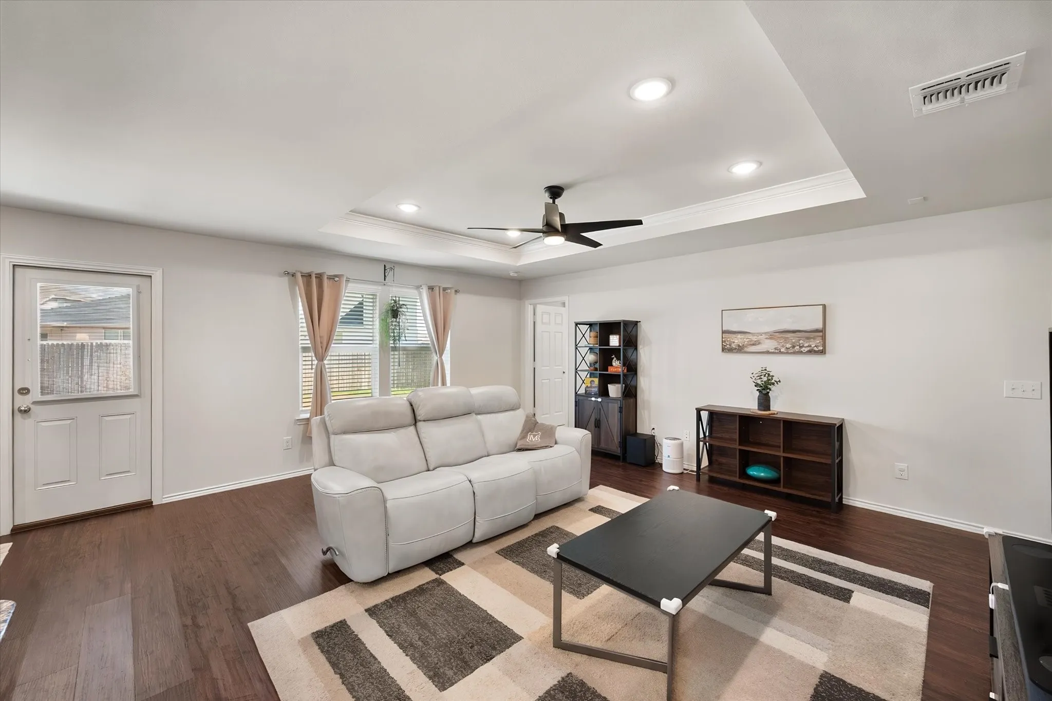 Tray ceiling with recessed lighting and crown molding