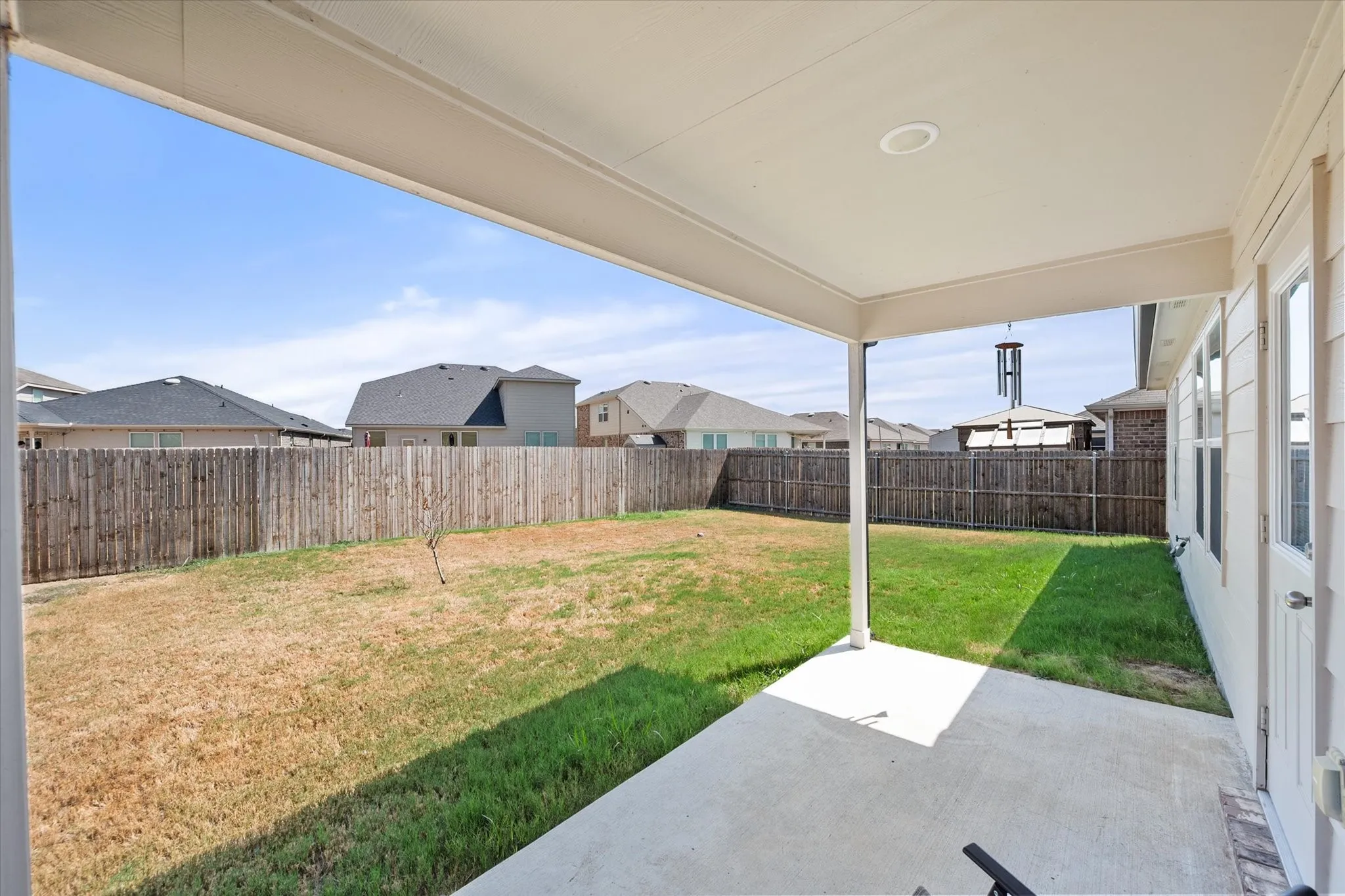 Covered patio with recessed lighting, concrete flooring, and a fenced backyard