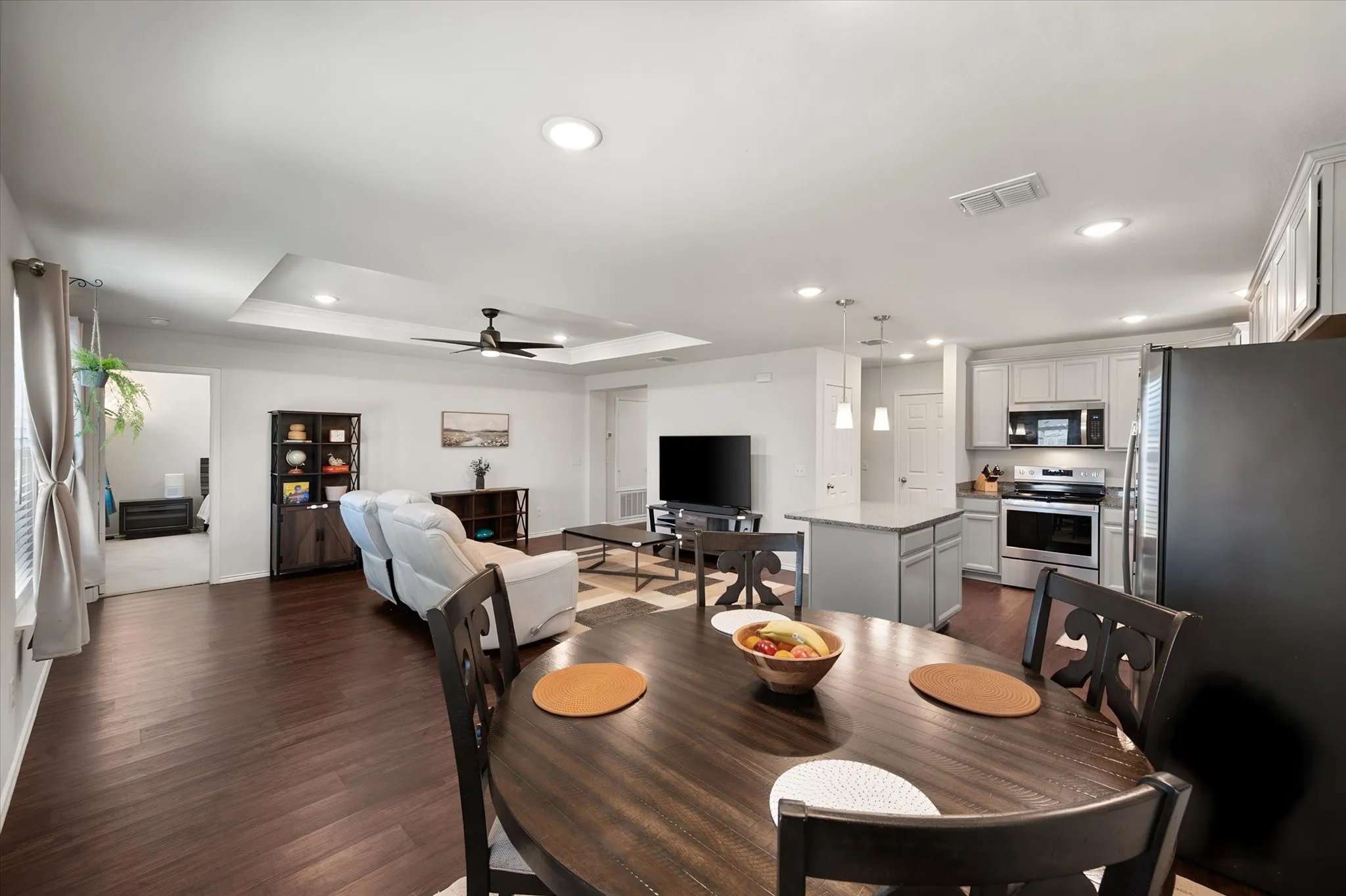 Open-concept living space with wood-finish flooring