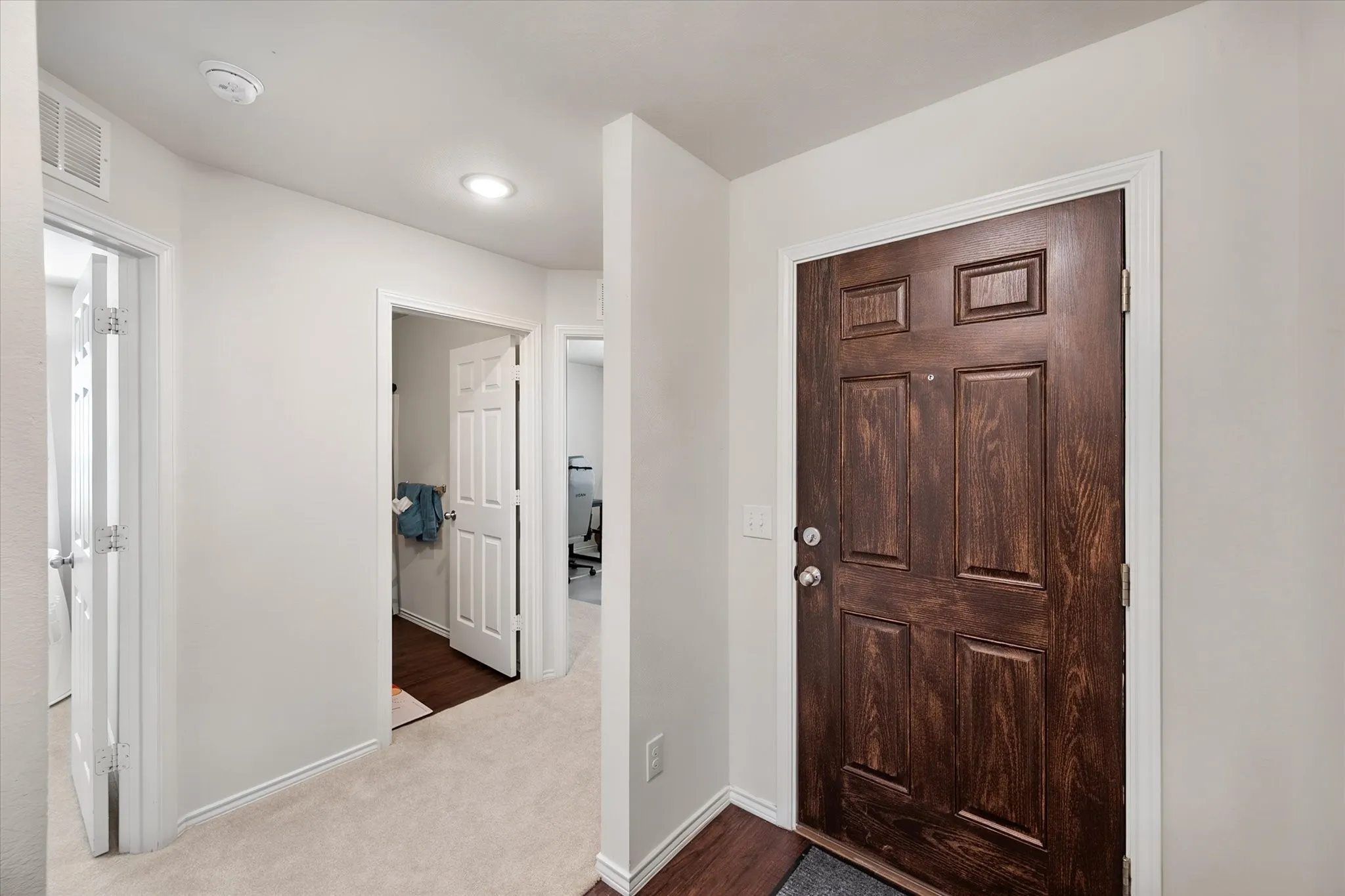 Dark wood-finish entry door with panel detailing