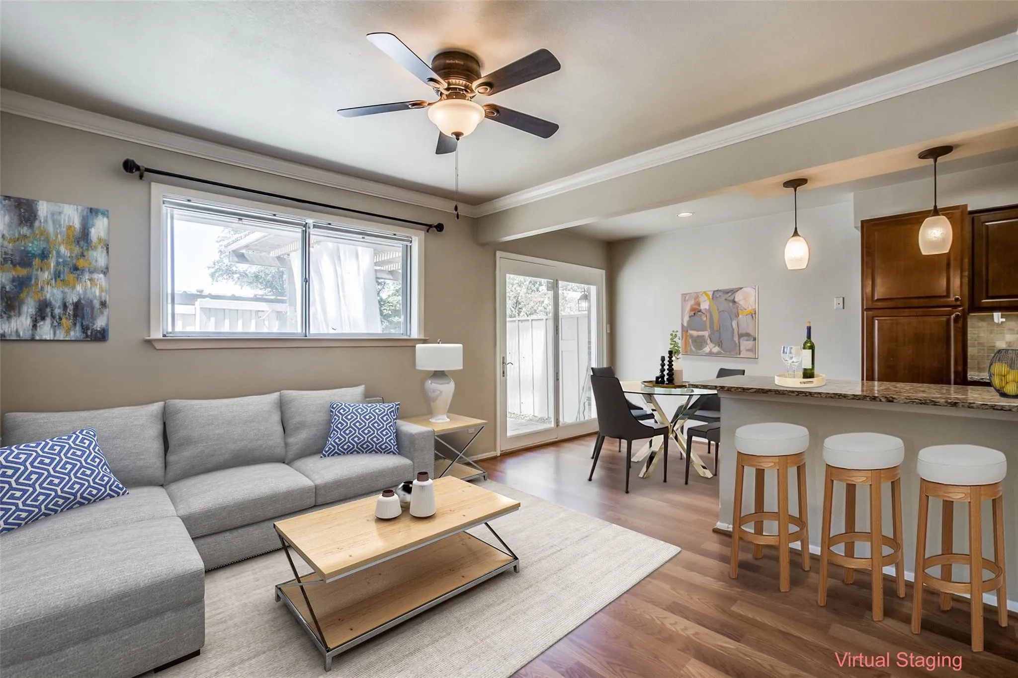 Wood-finish flooring, crown molding, and a ceiling fan with integrated lighting