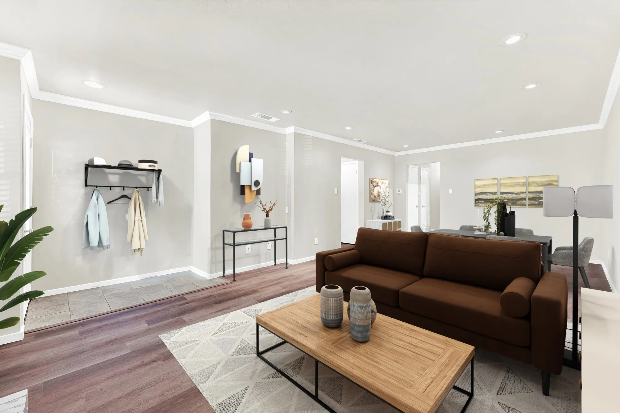 Open concept living area featuring recessed lighting, crown molding, and wood-finish flooring