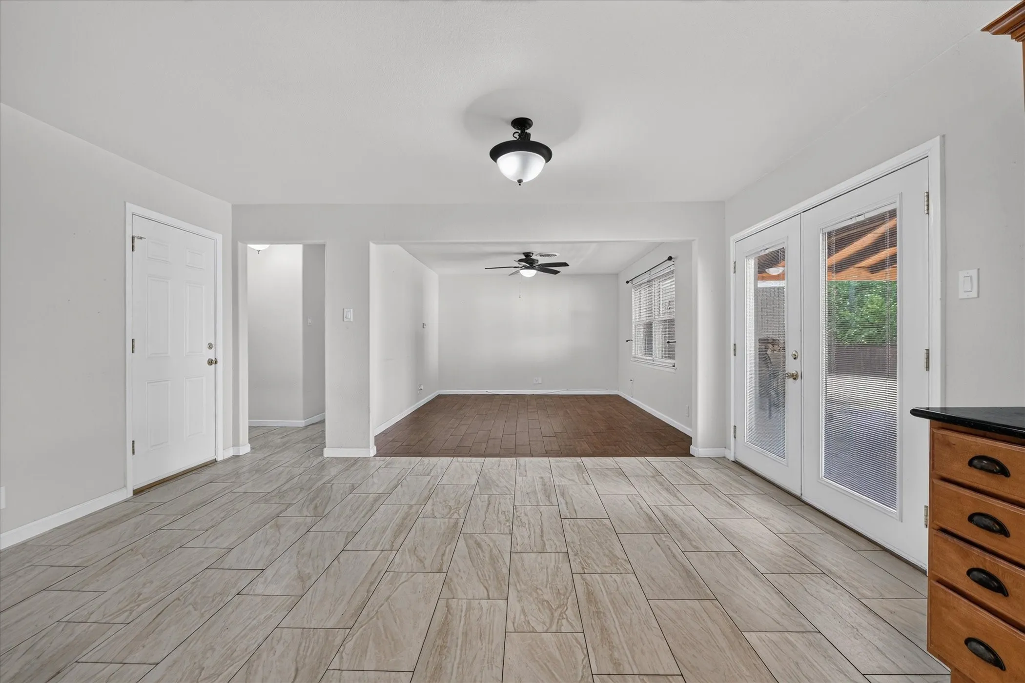 Dining area into living room, bedrooms hall to left