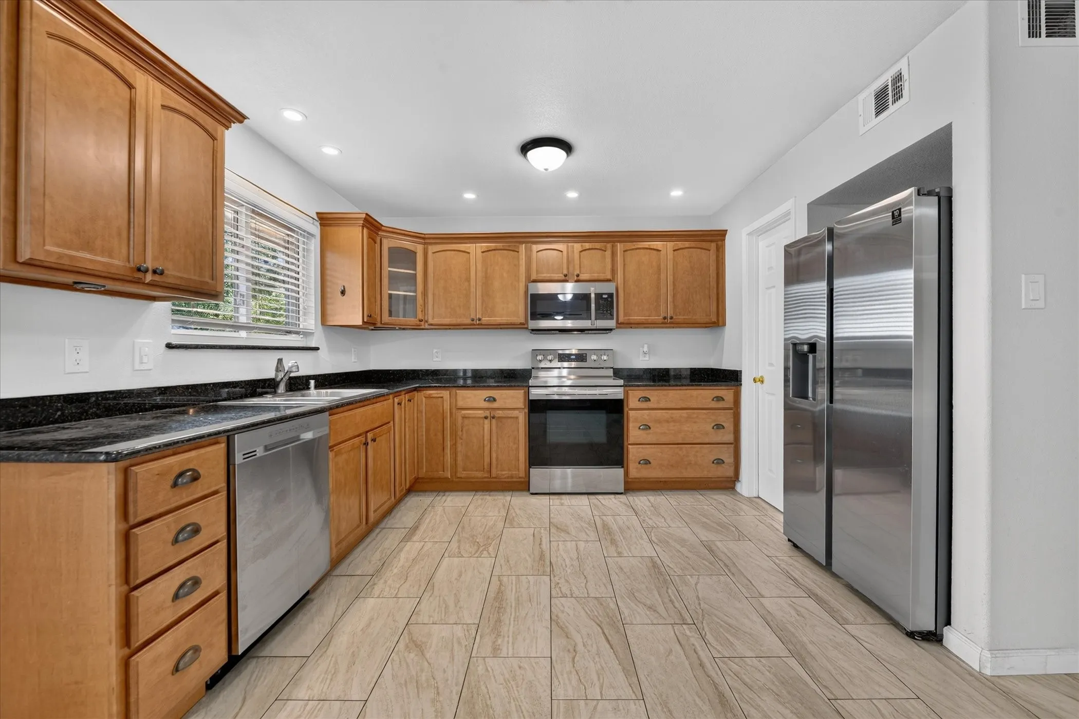 Wood cabinets and stainless steel appliances