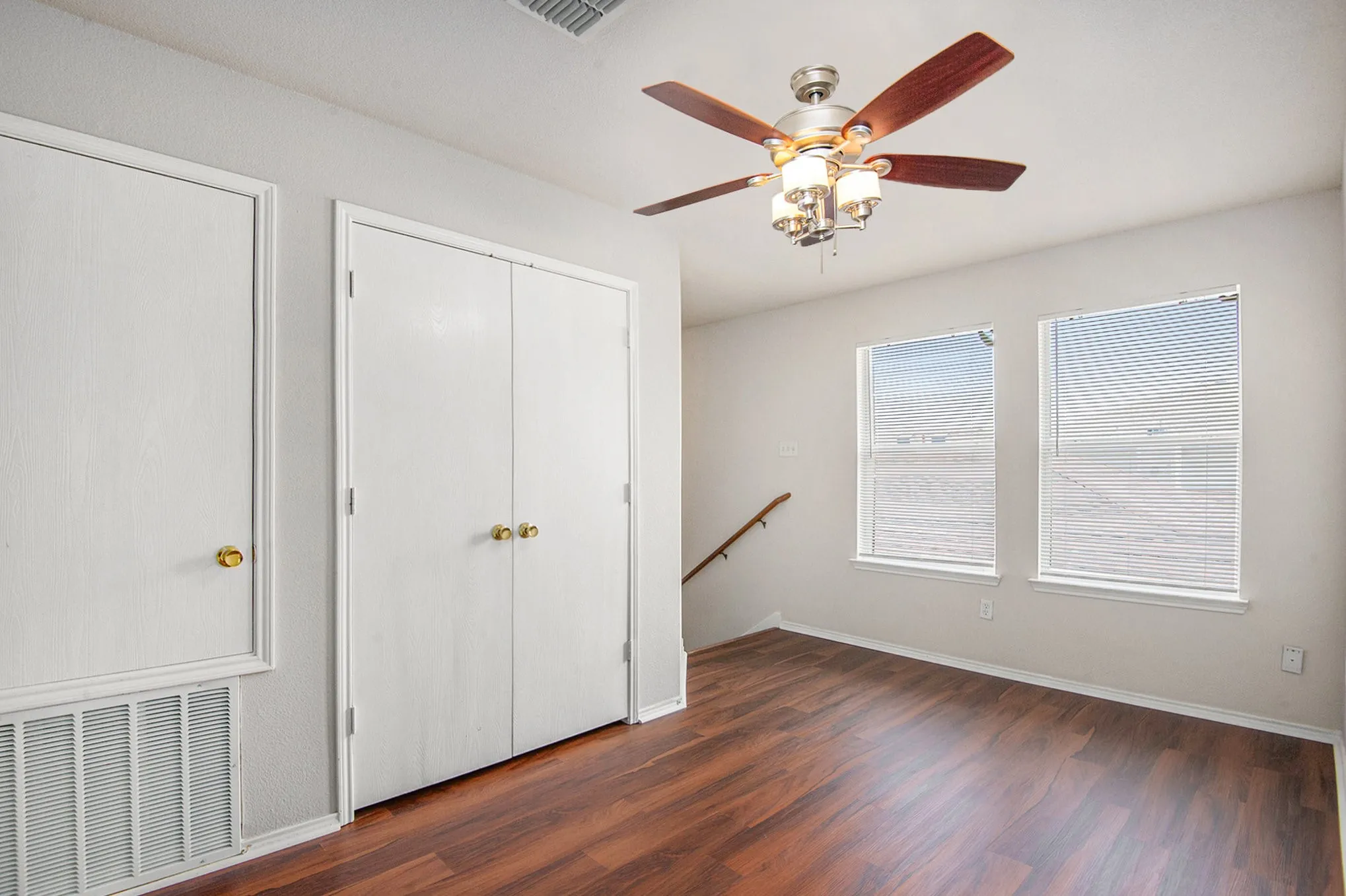 Unfurnished bedroom with wood finished floors and a ceiling fan