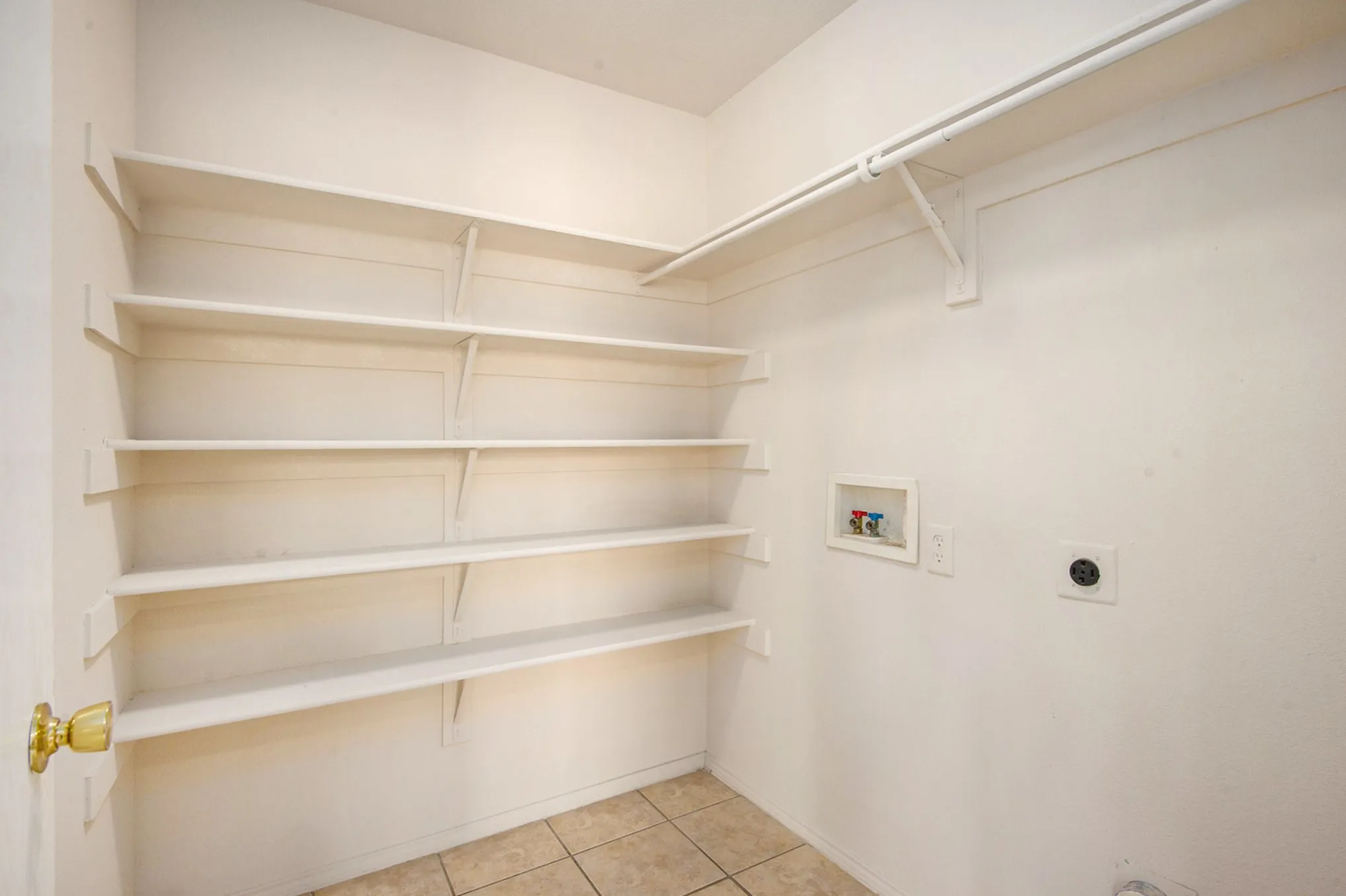 Laundry room with electric dryer hookup, washer hookup, and tile patterned flooring