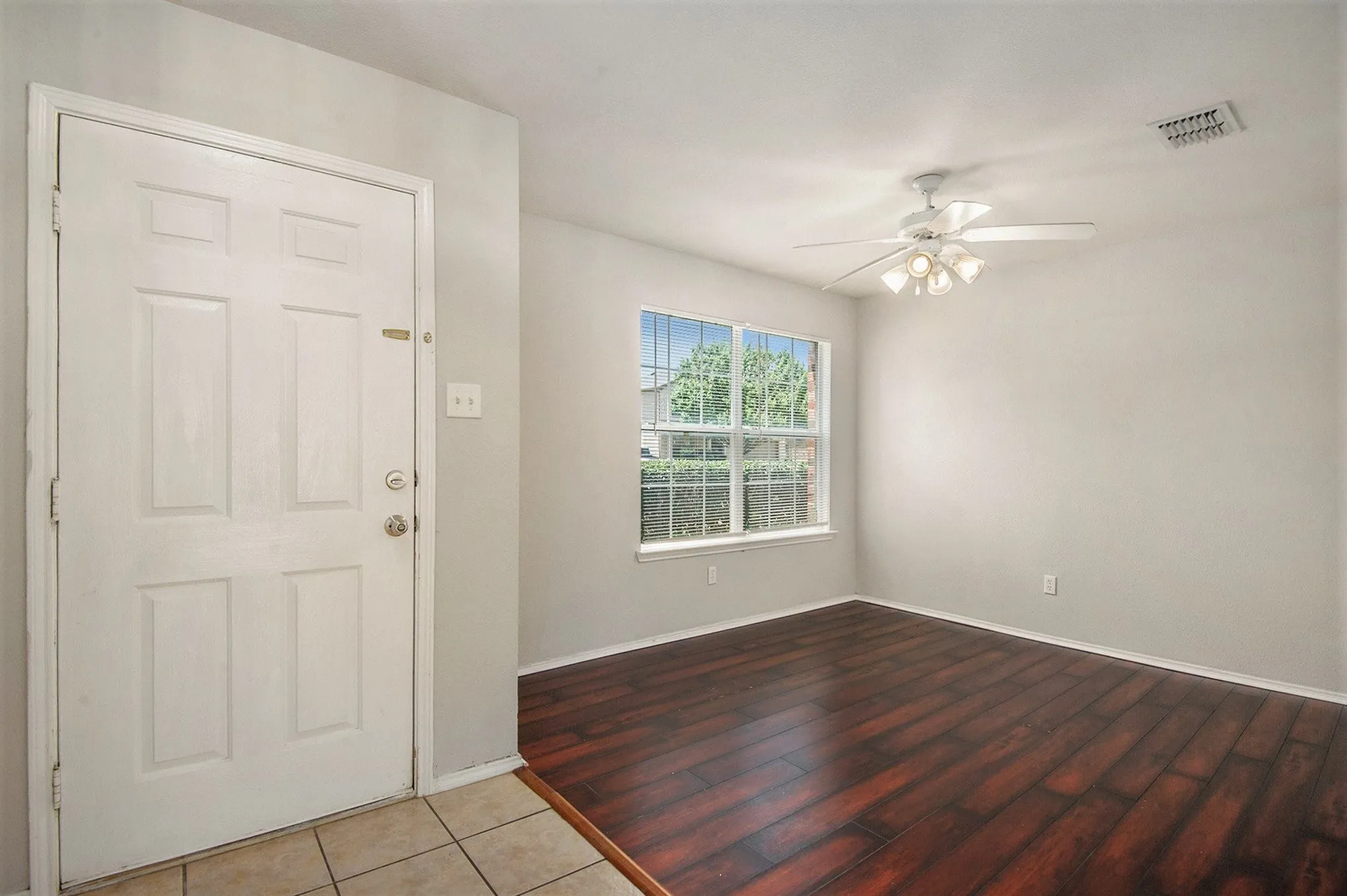 Entryway with a ceiling fan and wood finished floors