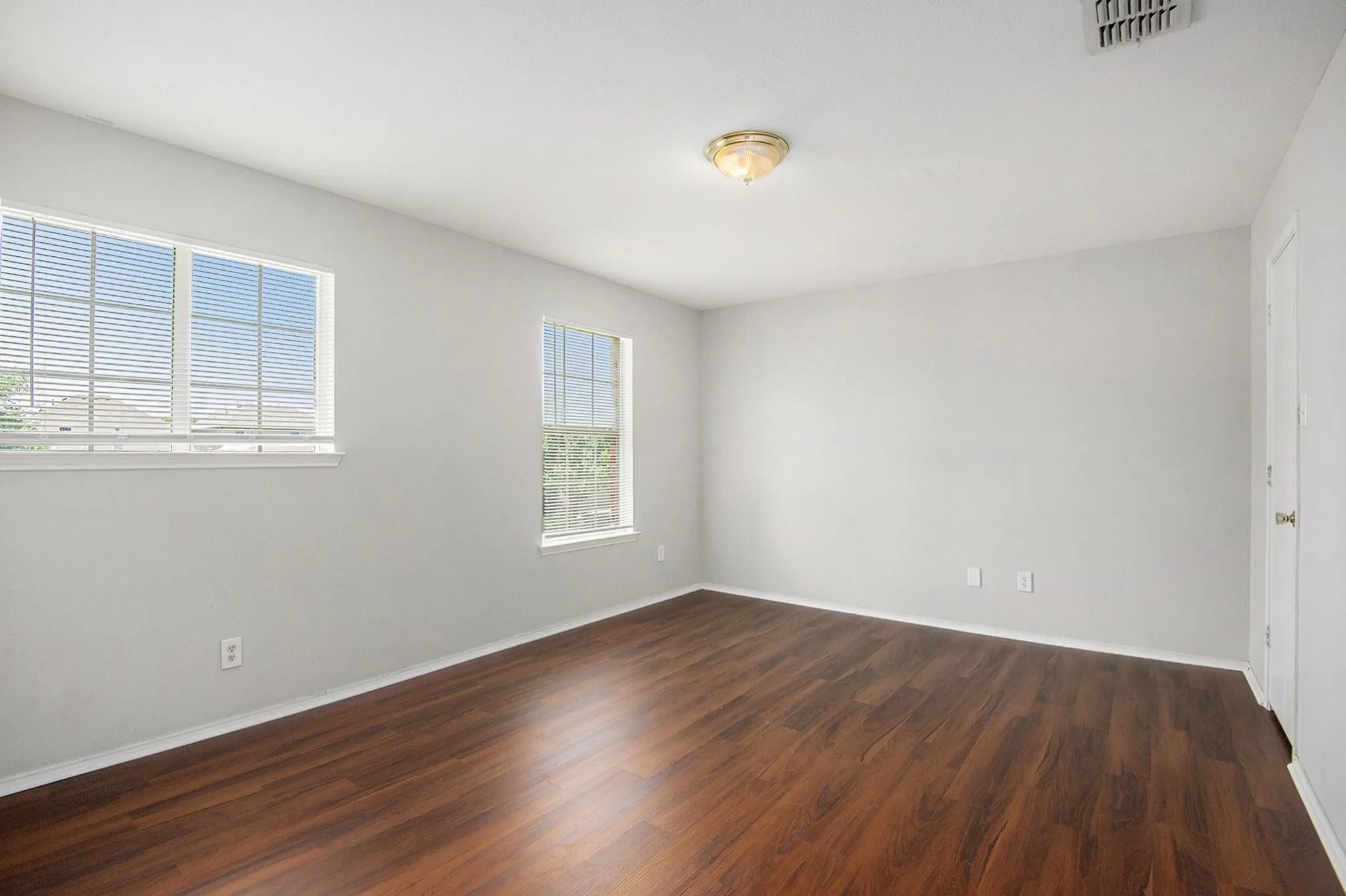 Unfurnished room featuring dark wood finished floors and baseboards