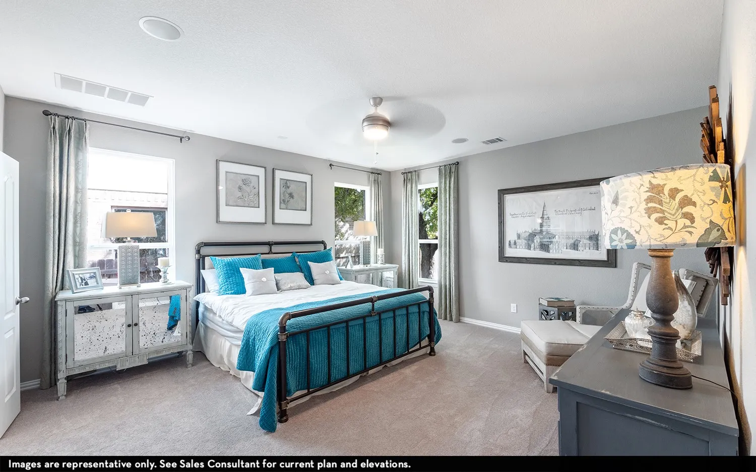 Soft gray wall paint, light-colored carpeting, multiple windows with drapes, and a ceiling fan with integrated lighting