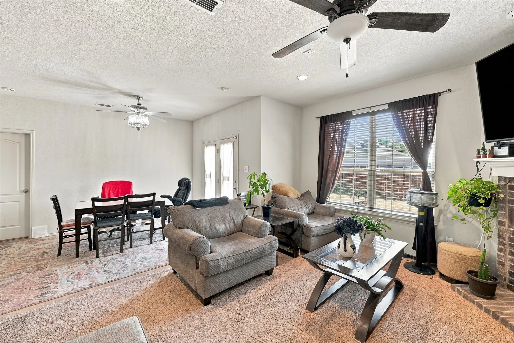 Recessed lighting, ceiling fans, and a window with horizontal blinds