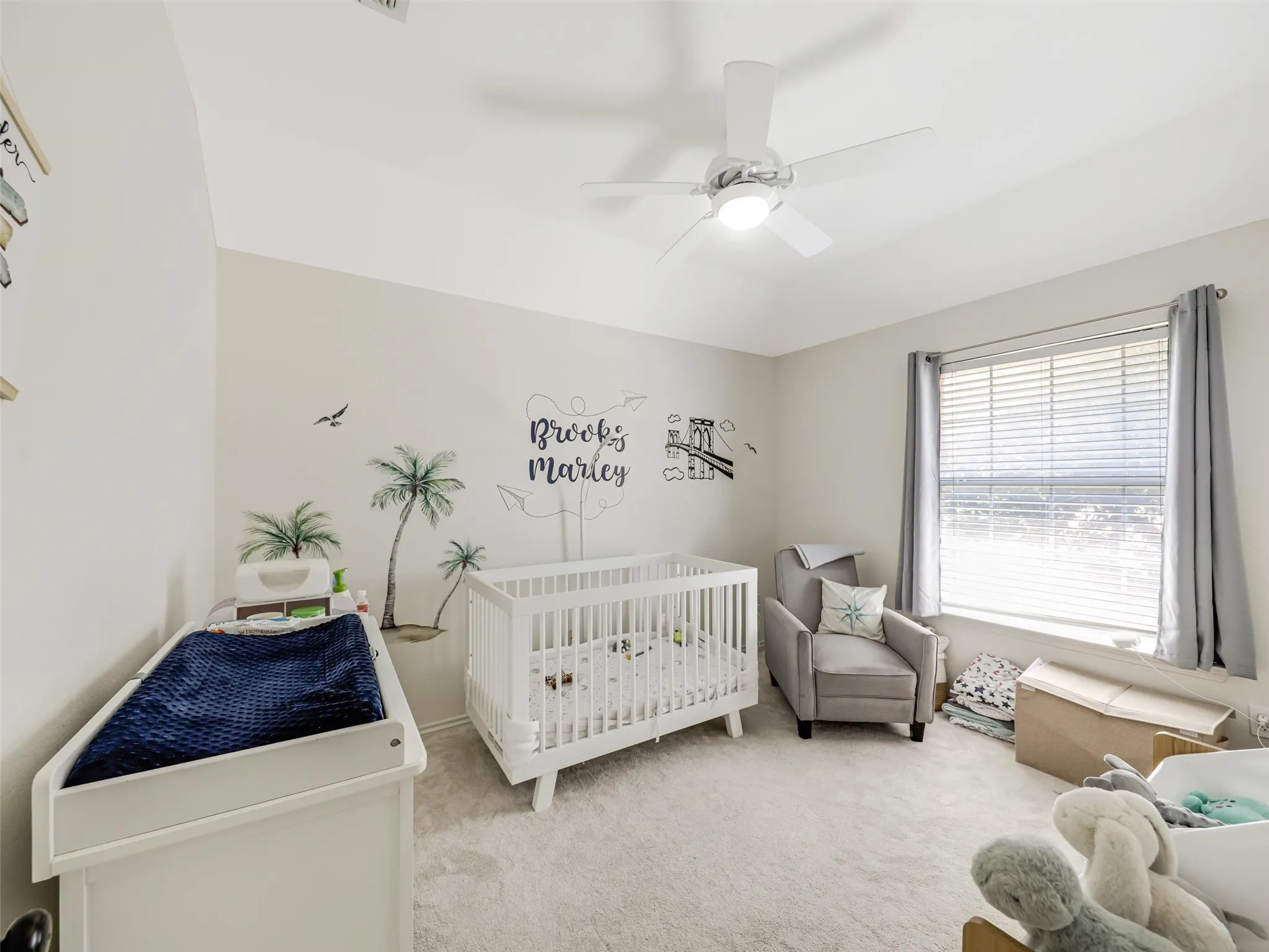 Recessed lighting, ceiling fan with light fixture, large window with blinds, light gray wall paint, and light-colored carpeting throughout