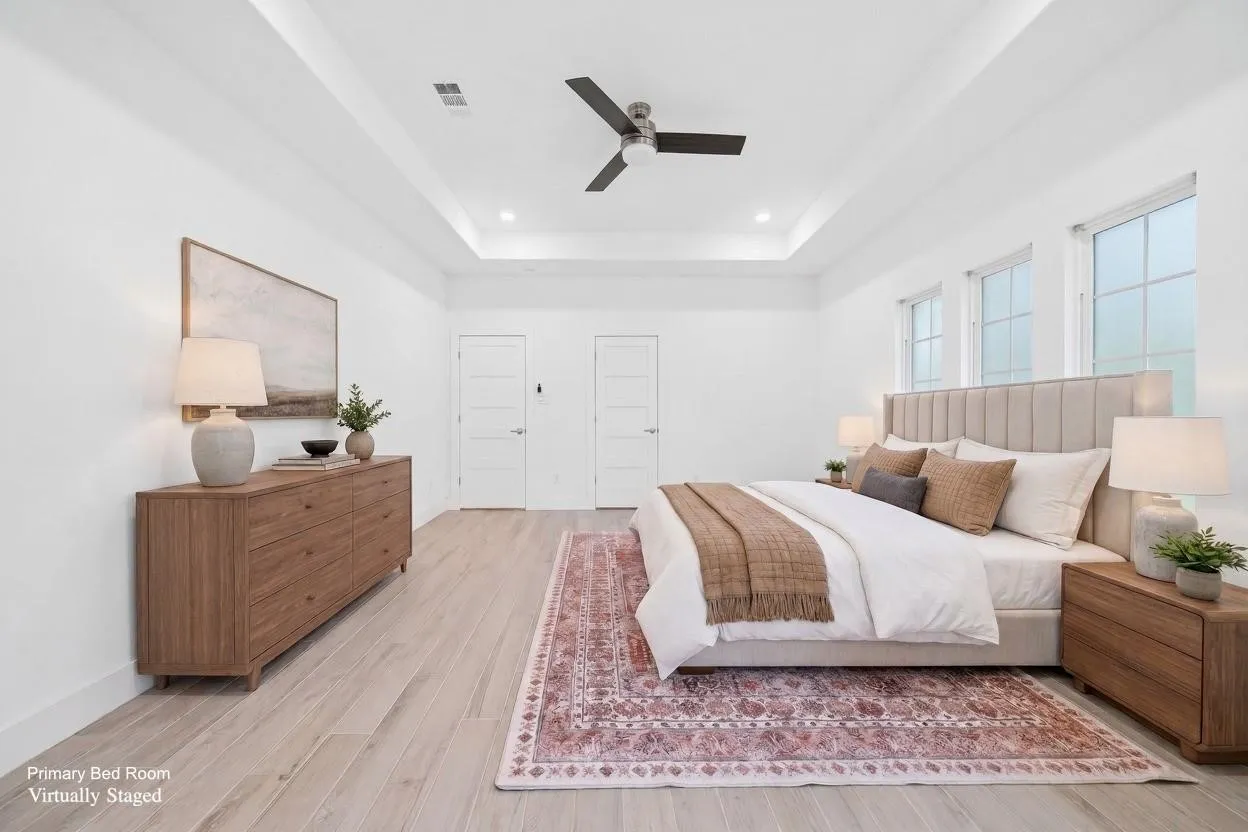 Tray ceiling with recessed lighting and a ceiling fan, wood-finish flooring, and multiple windows
