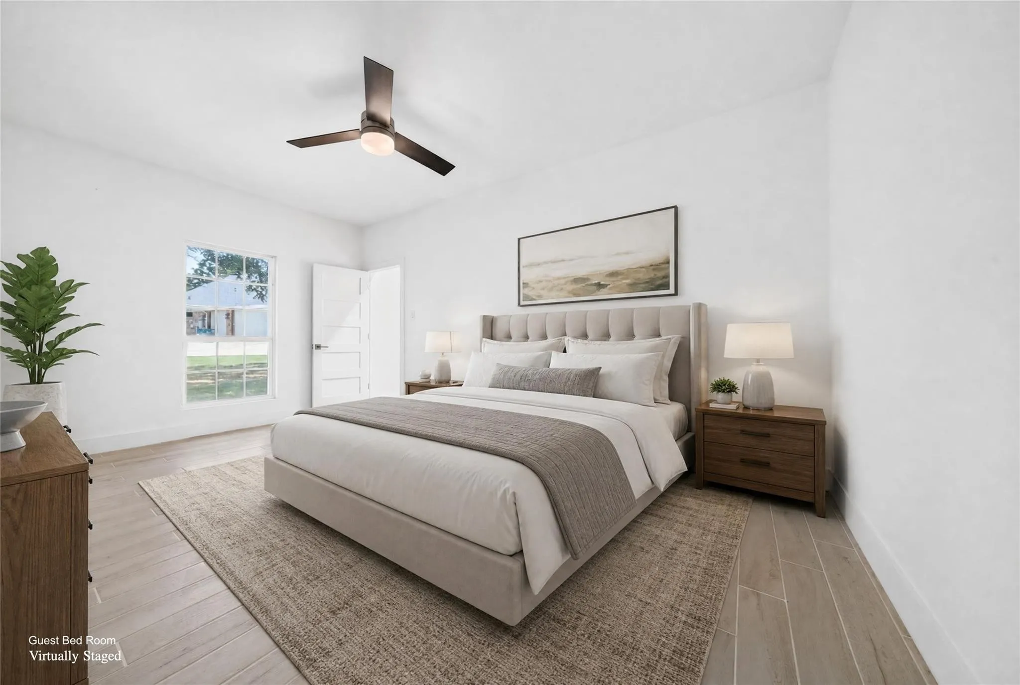 Light-filled room featuring wood-finish flooring, a contemporary ceiling fan, and a paneled door