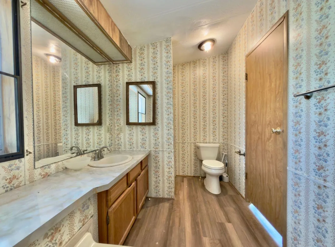 Vanity with a single basin, wood-finish cabinetry, and an integrated countertop
