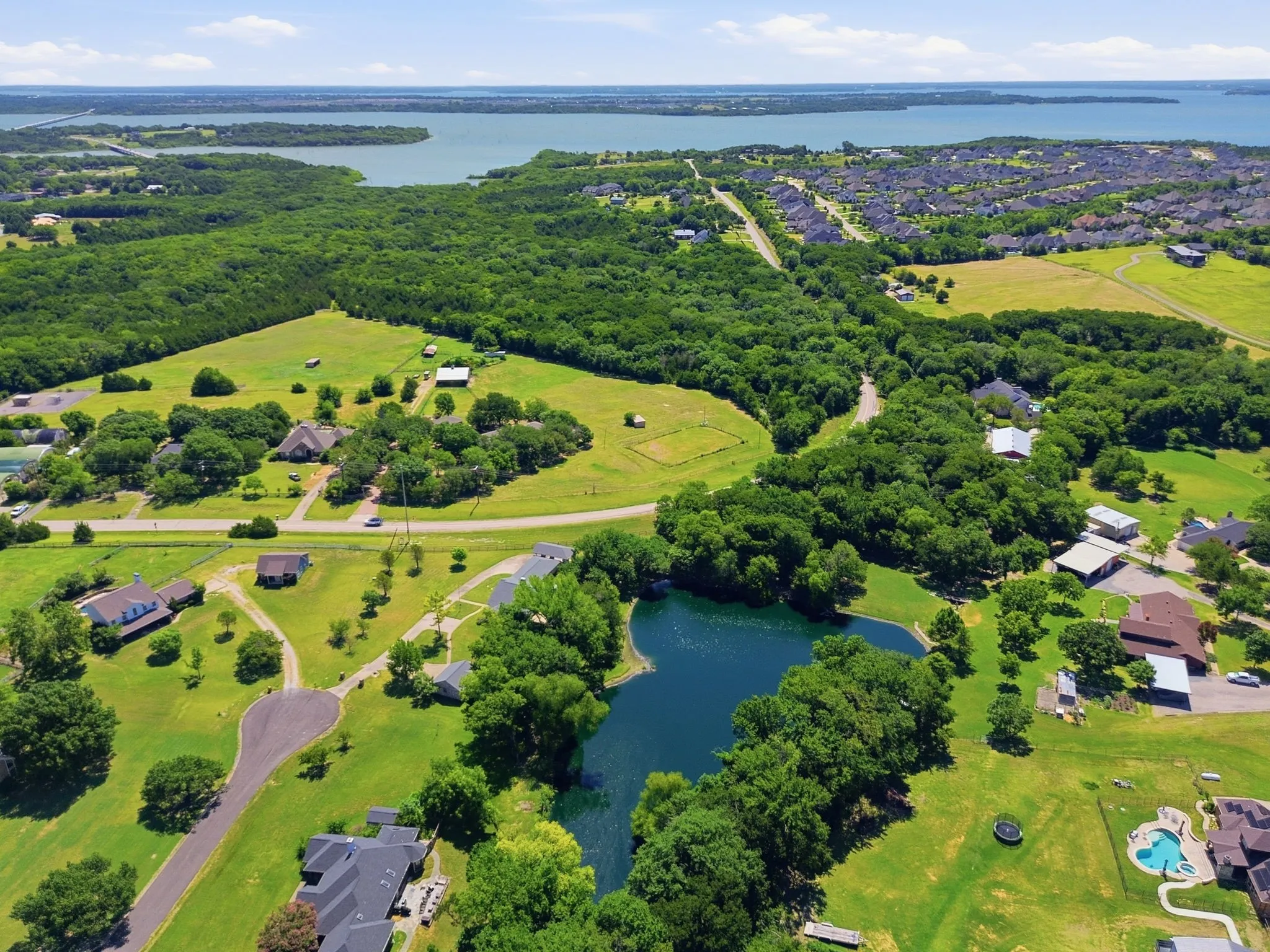 Expansive acreage with a private pond, mature trees, and Lake Lavon