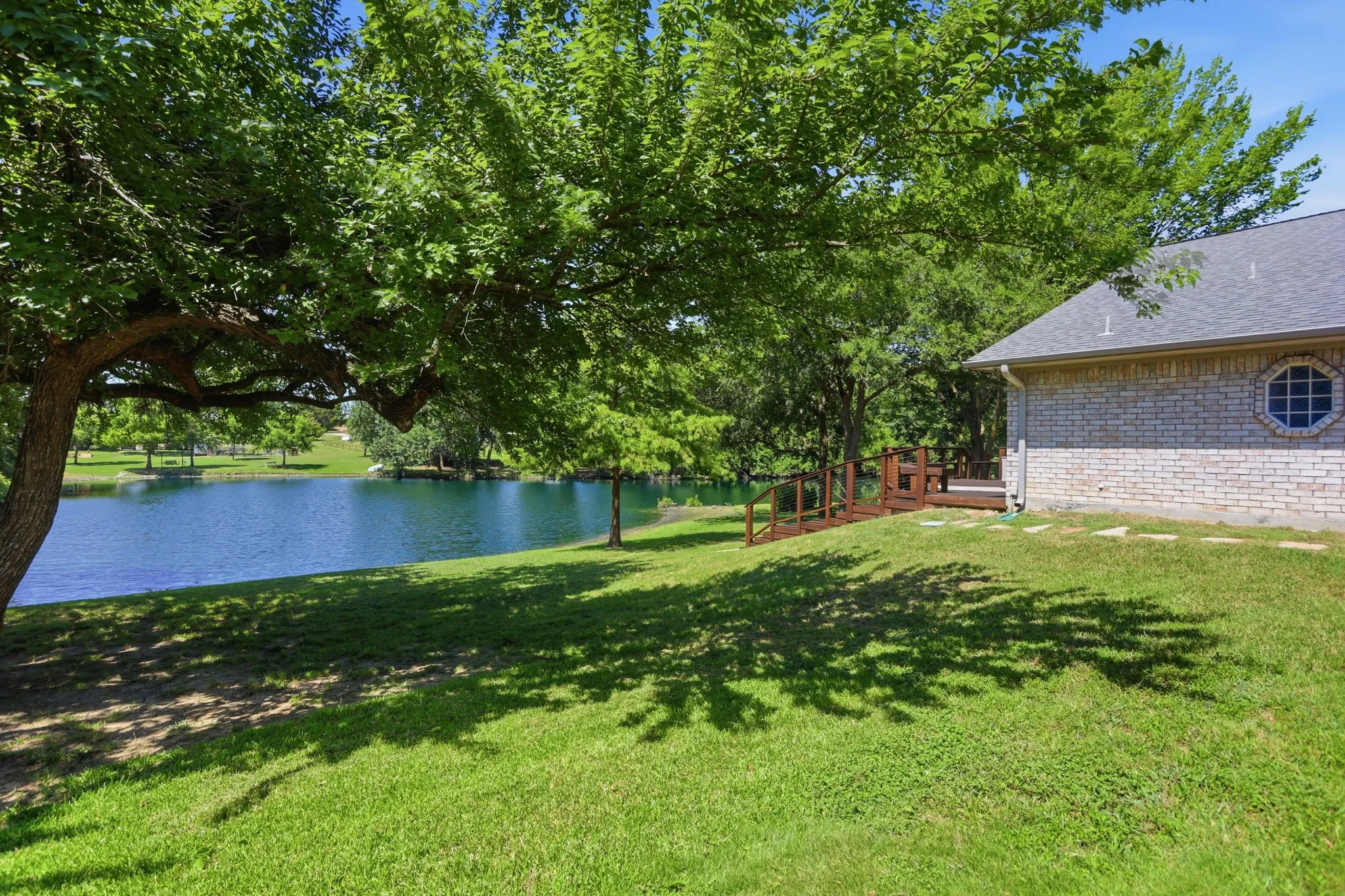 Brick exterior, attached garage, covered RV storage, concrete driveway, front lawn