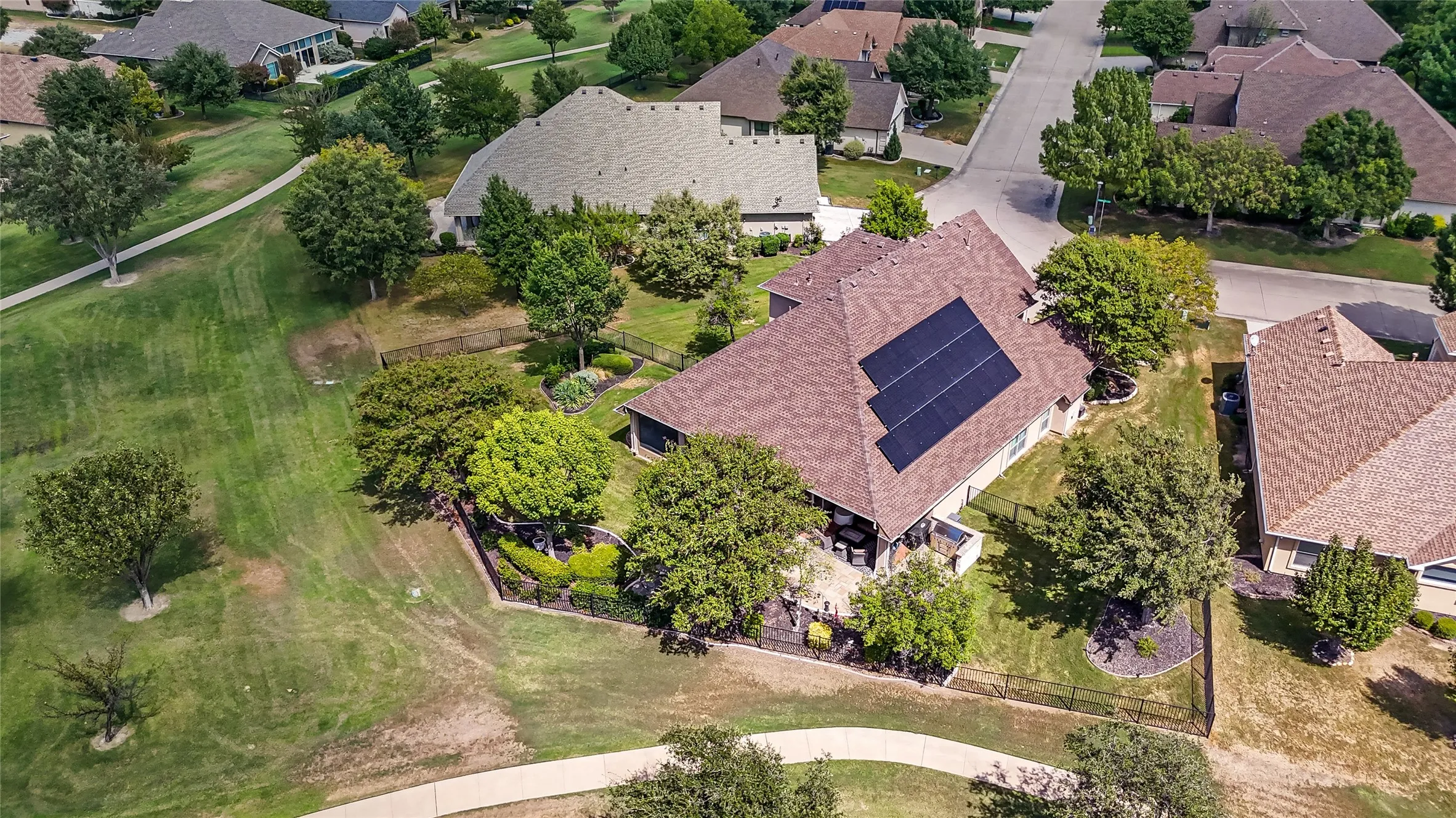 Expansive property featuring a private backyard, mature trees, a covered patio, and rooftop solar panels