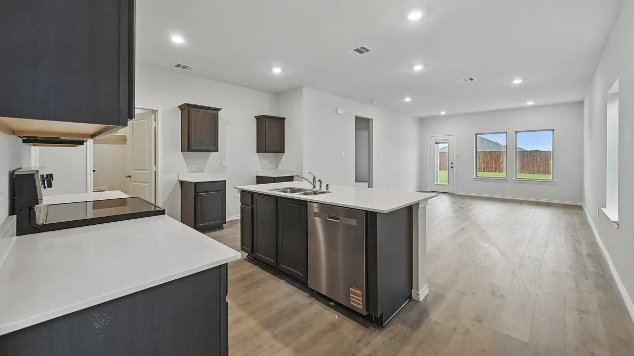 Open-concept kitchen and living area featuring wood-finish flooring