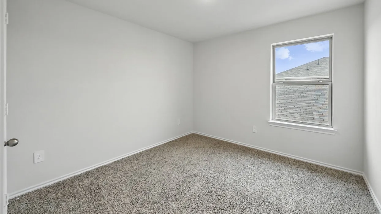 Room featuring light neutral walls, gray carpet flooring, and white trim