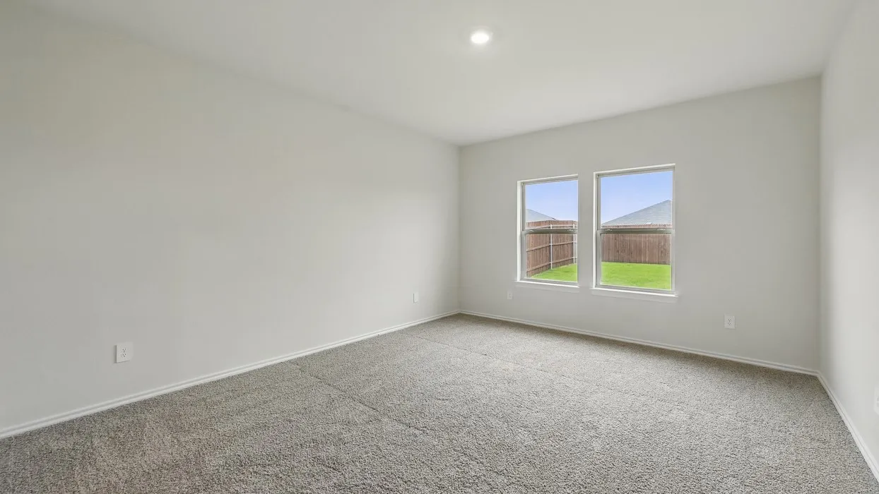 Spacious room with plush gray carpeting, two large windows, white walls, and recessed lighting
