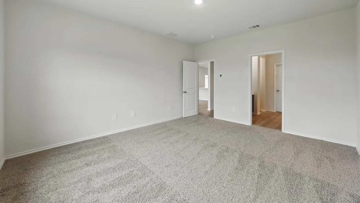 Spacious room featuring light gray carpeting, neutral wall finishes, white trim, and recessed lighting