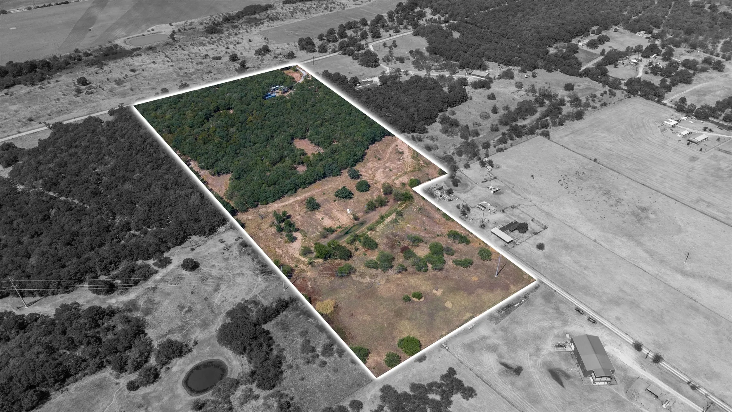 Expansive acreage with mixed terrain, including wooded areas and open clearings