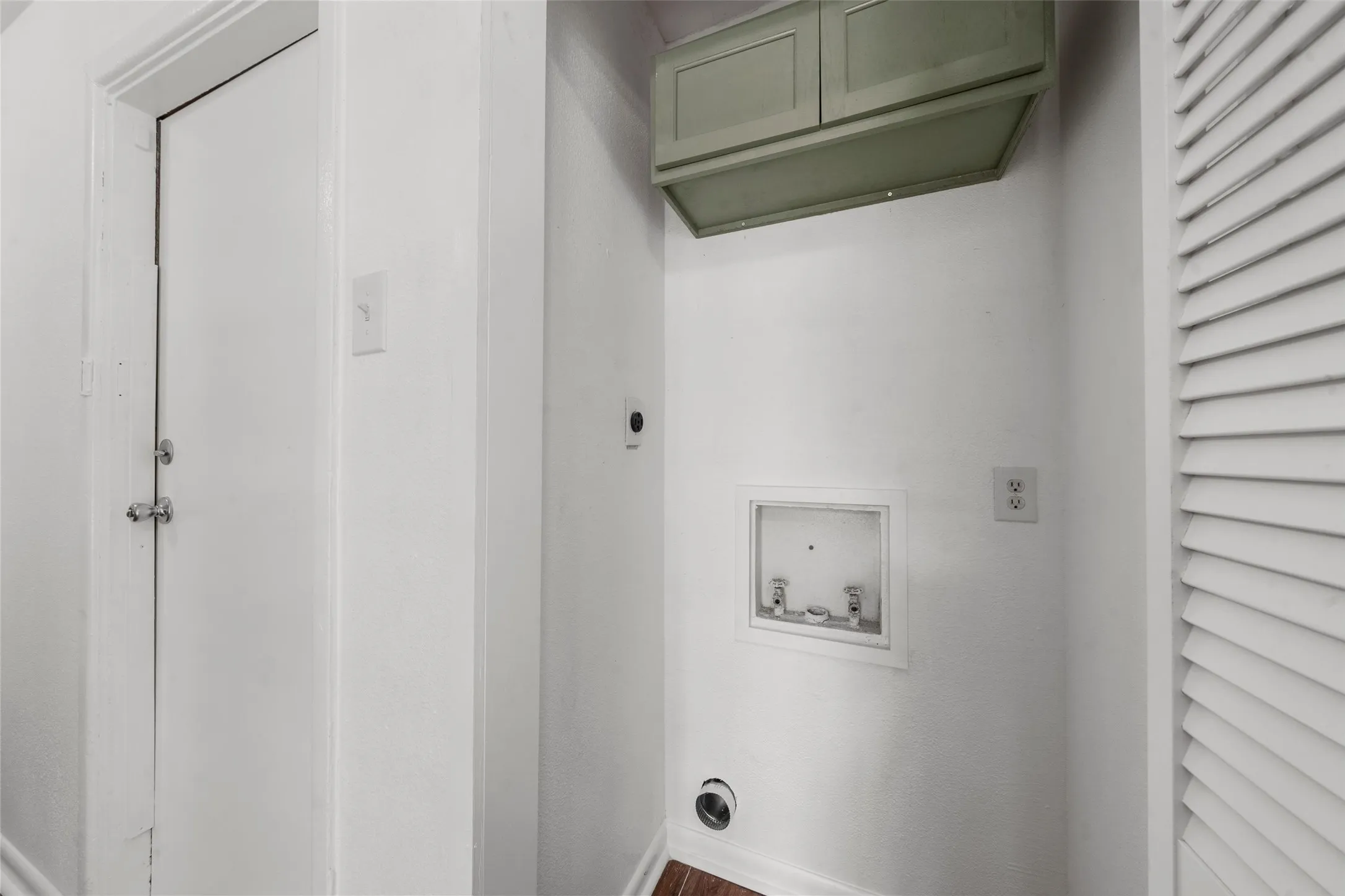 Built-in cabinetry with paneled doors and a louvered door closet
