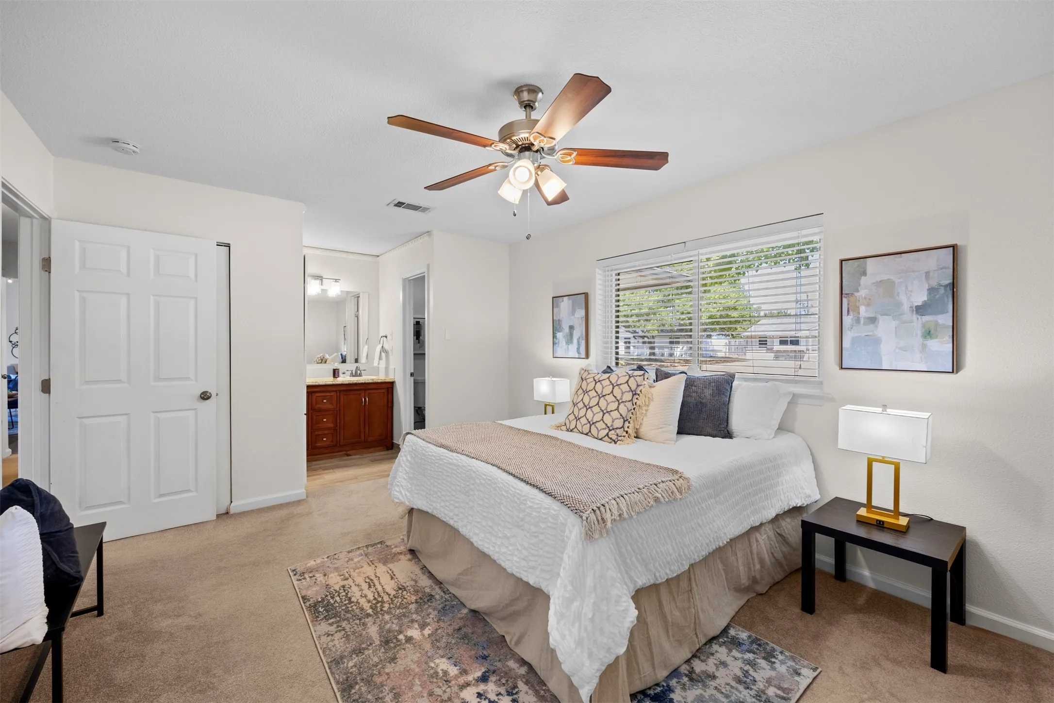 Bedroom featuring a ceiling fan with light fixture, window with blinds, and carpet flooring