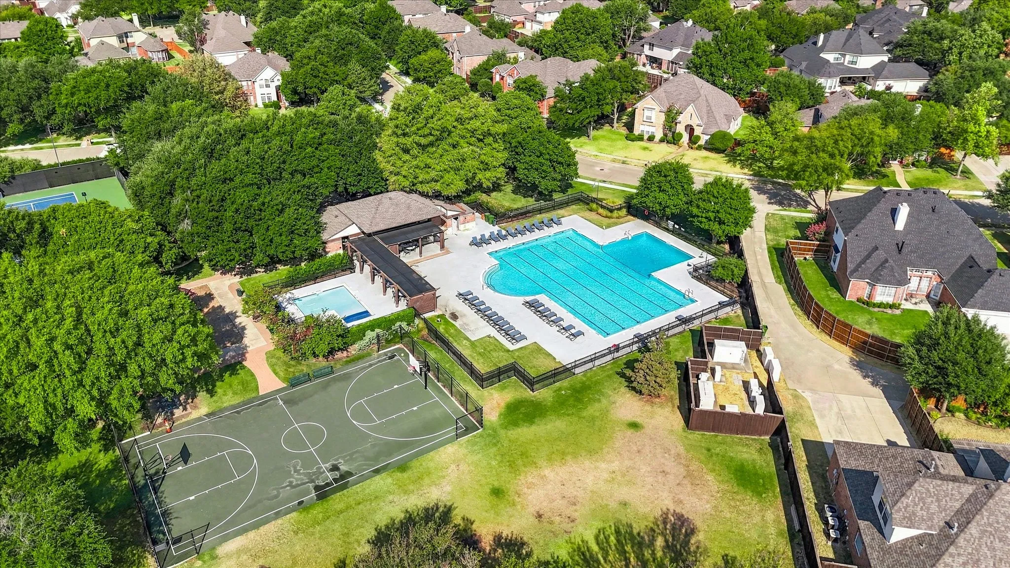 Community amenities featuring a large swimming pool, a second smaller pool, a basketball court, and a tennis court