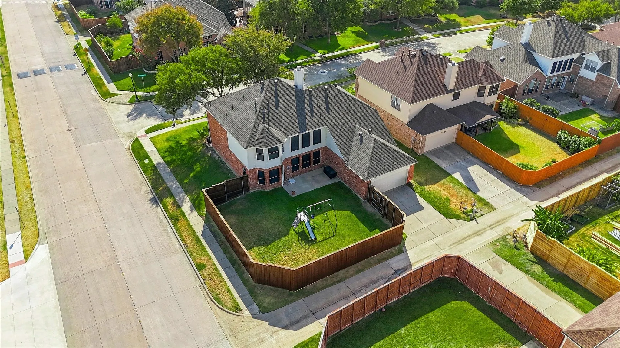 Brick and siding exterior with a dark shingle roof