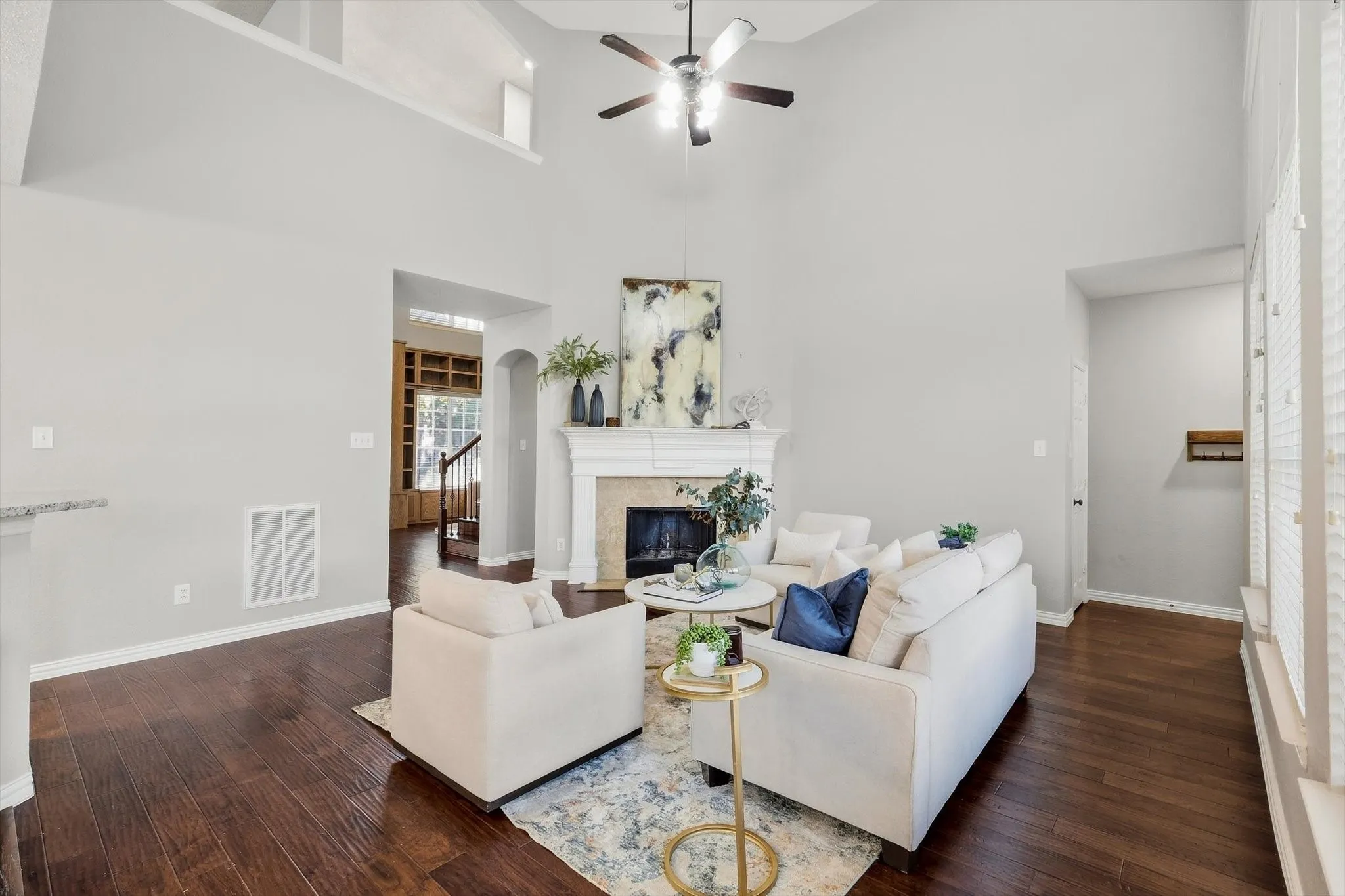 Soaring vaulted ceiling with wood-finish flooring