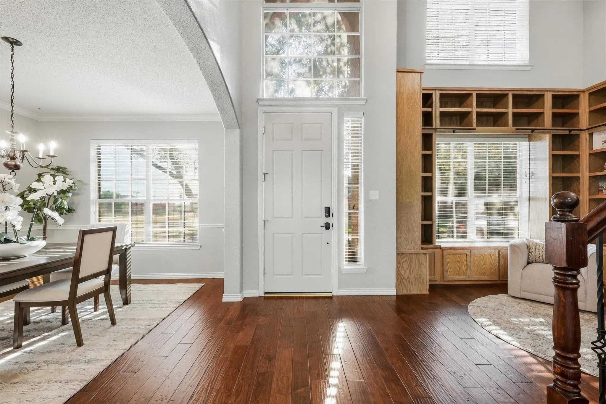 Hardwood-finish flooring, built-in shelving, vaulted ceiling, multi-pane windows, and a traditional paneled door
