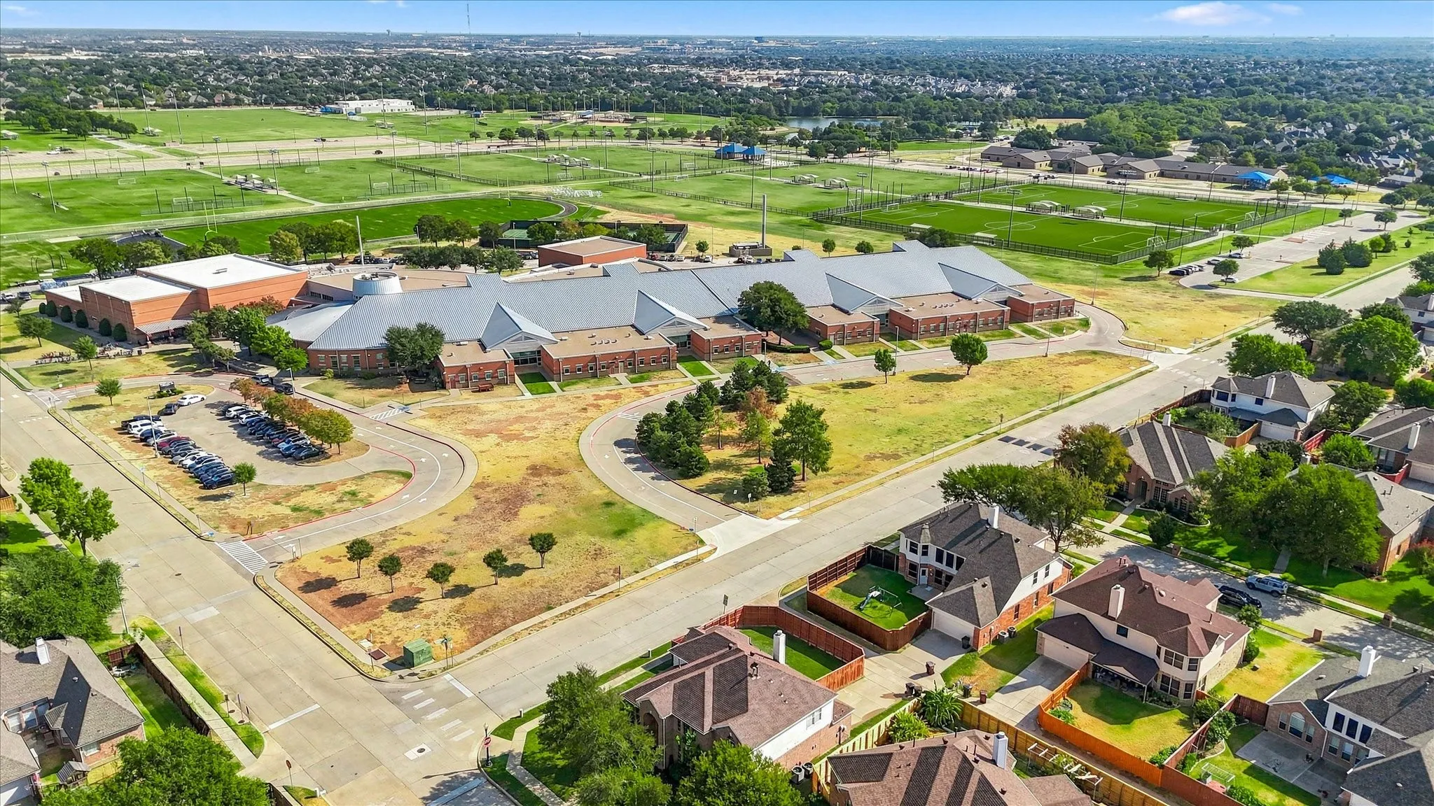Aerial perspective showcasing residential properties with established landscaping and paved roadways